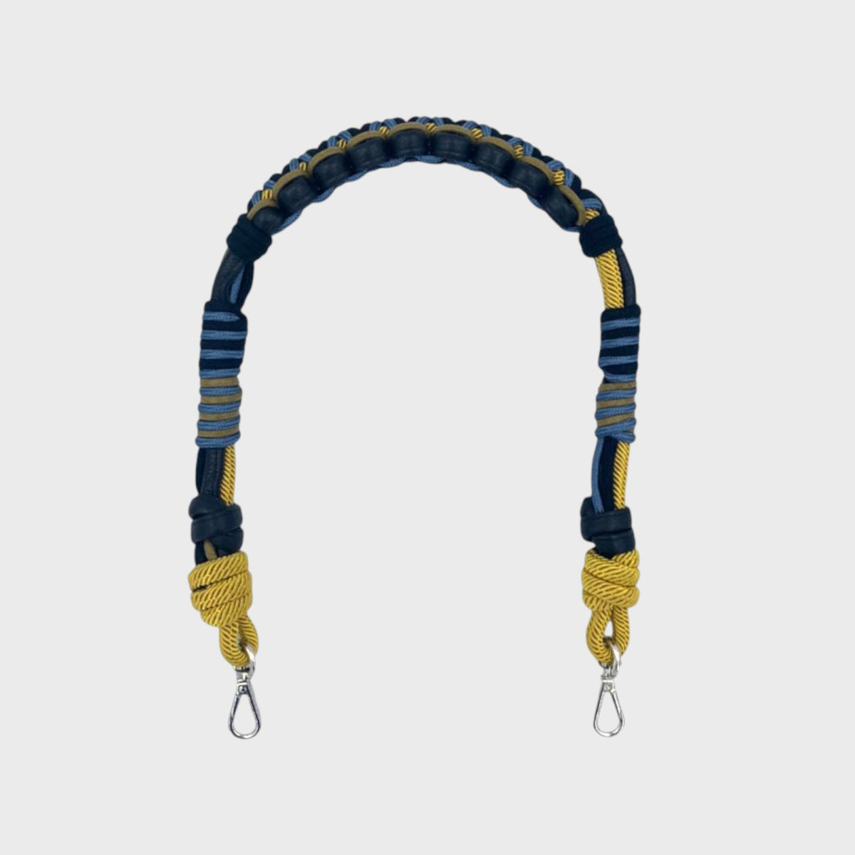 A macramé bag strap with black leather and yellow, blue and grey patterns.