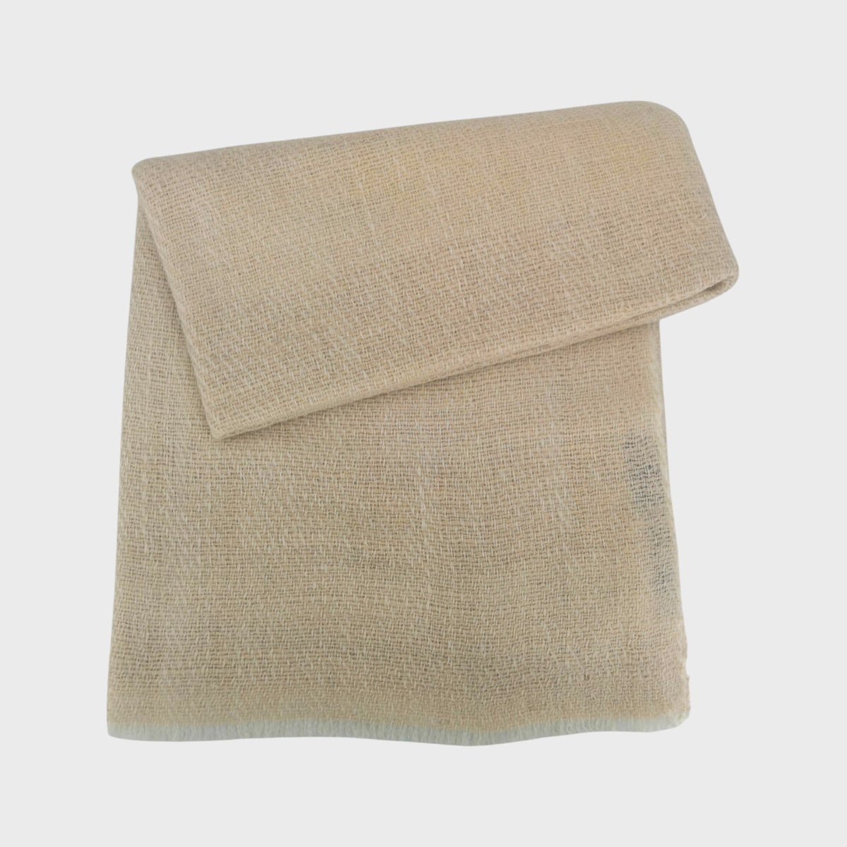Beige cashmere shawl or scarf on a light gray background