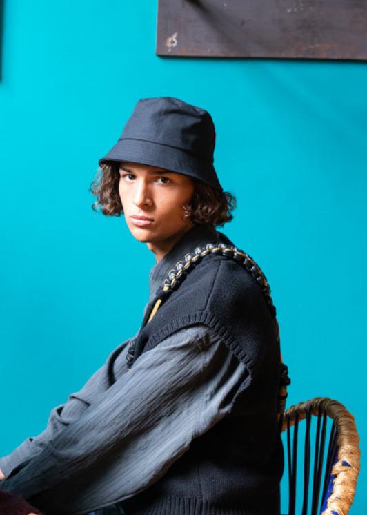 A man wearing a black cotton bucket hat.