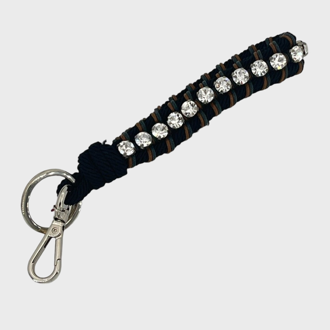 Keychain with black and brown patterned band and rhinestones on a white background