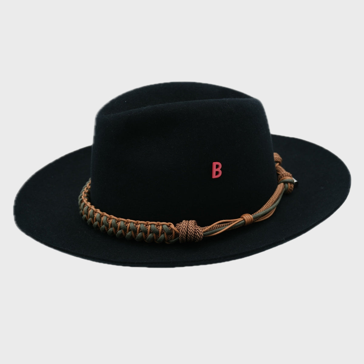 Black fedora hat with a woven macramé brown and green band on a light gray background