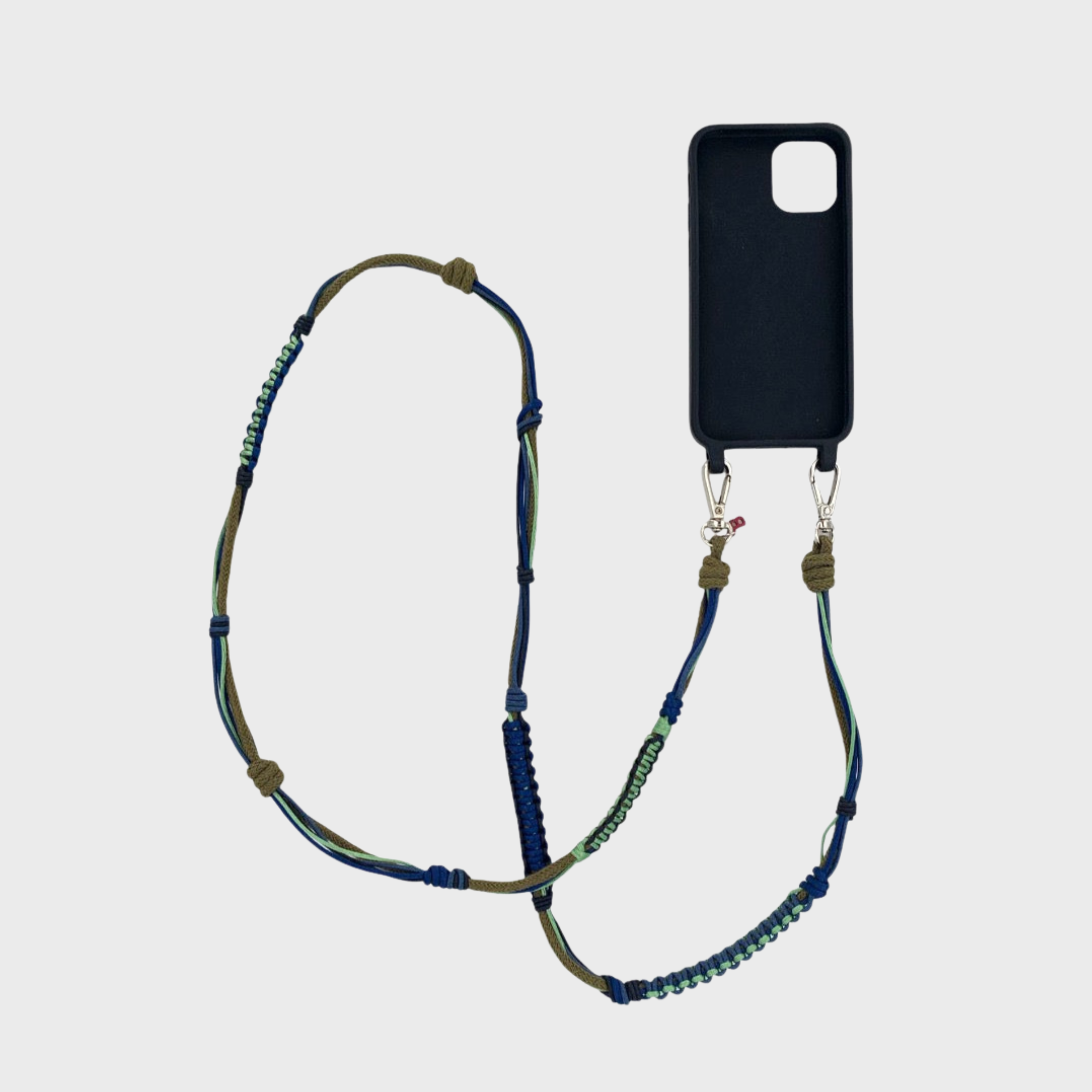 Brown, light green and dark blue macramé woven phone lanyard with a black phone case on a white background.