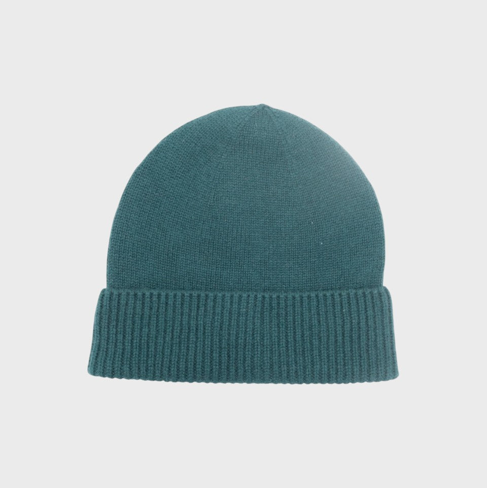 Teal cashmere knit bonnet on a light gray background