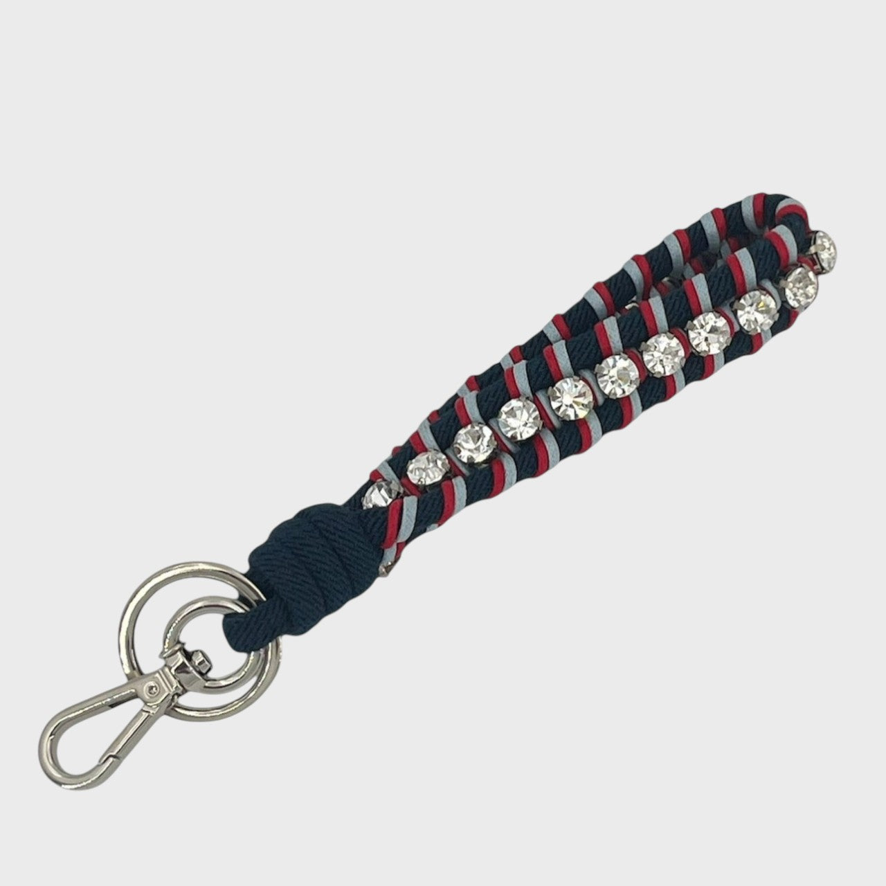 Keychain with dark blue and red patterned band and rhinestones on a white background