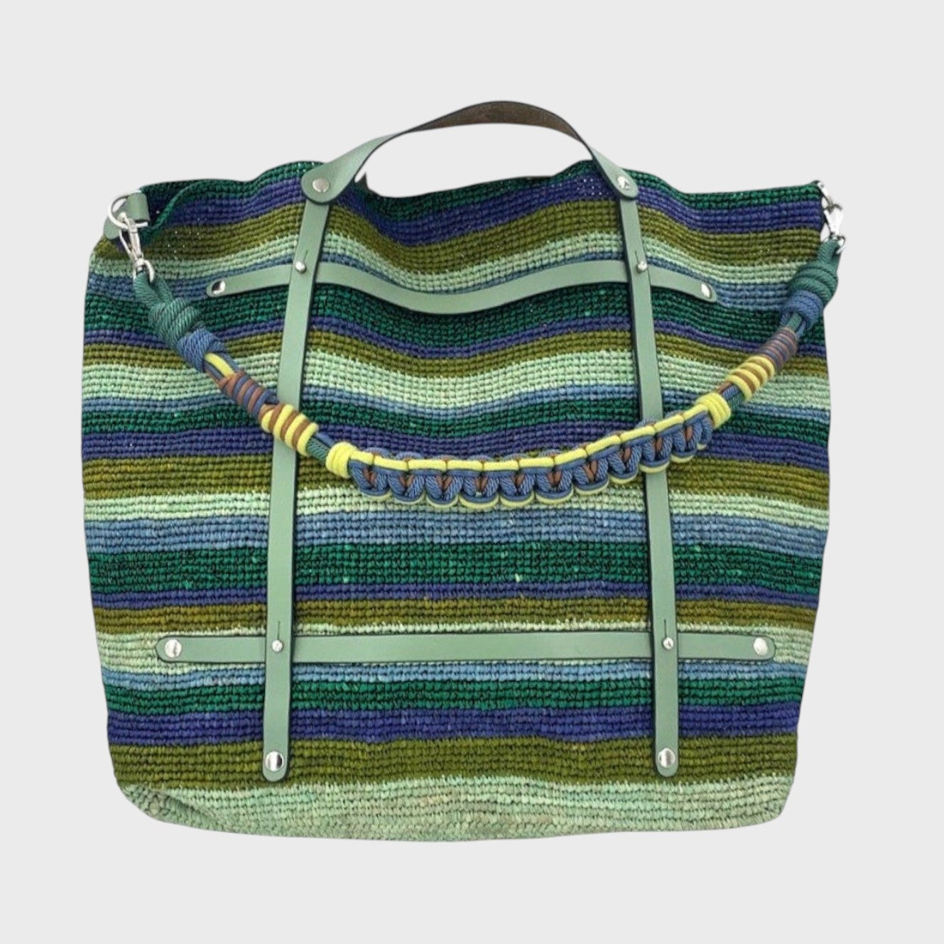 Blue and green striped raffia weekend or duffle bag with a green leather harness, paired with a colourful shoulder strap in blue, green, yellow and brown.