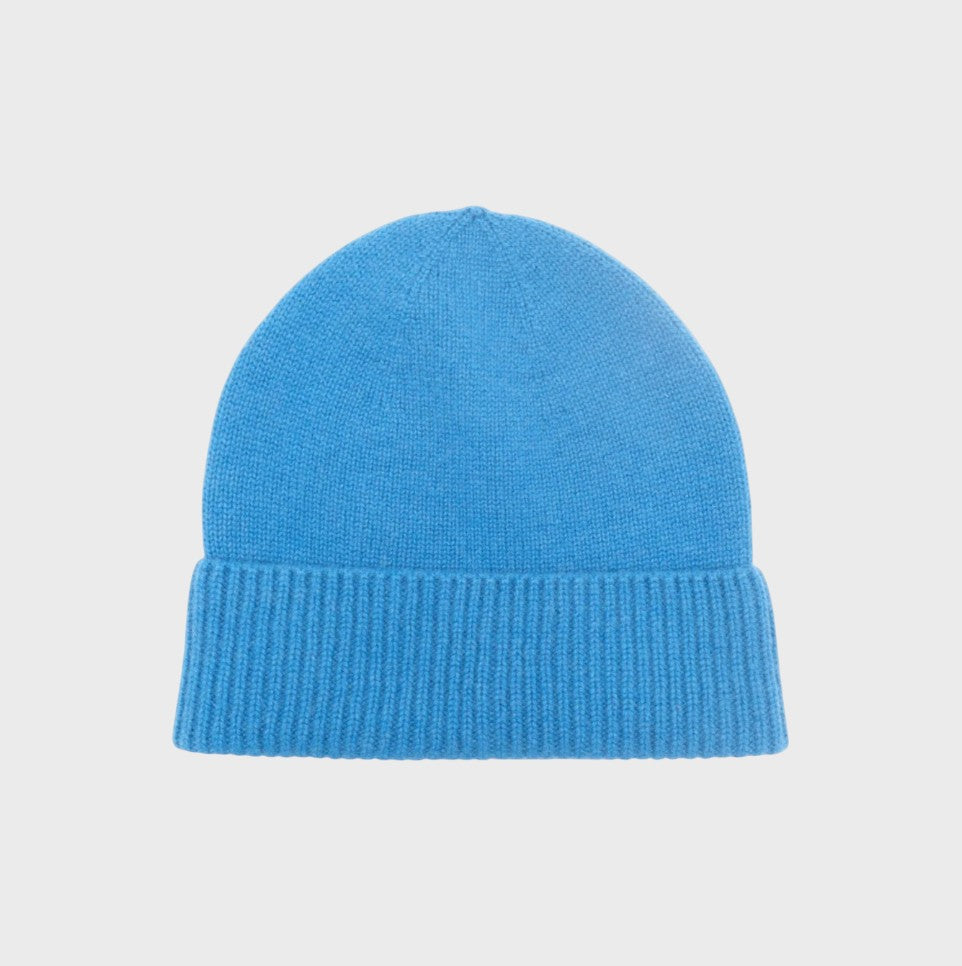 Blue cashmere knit bonnet on a light gray background