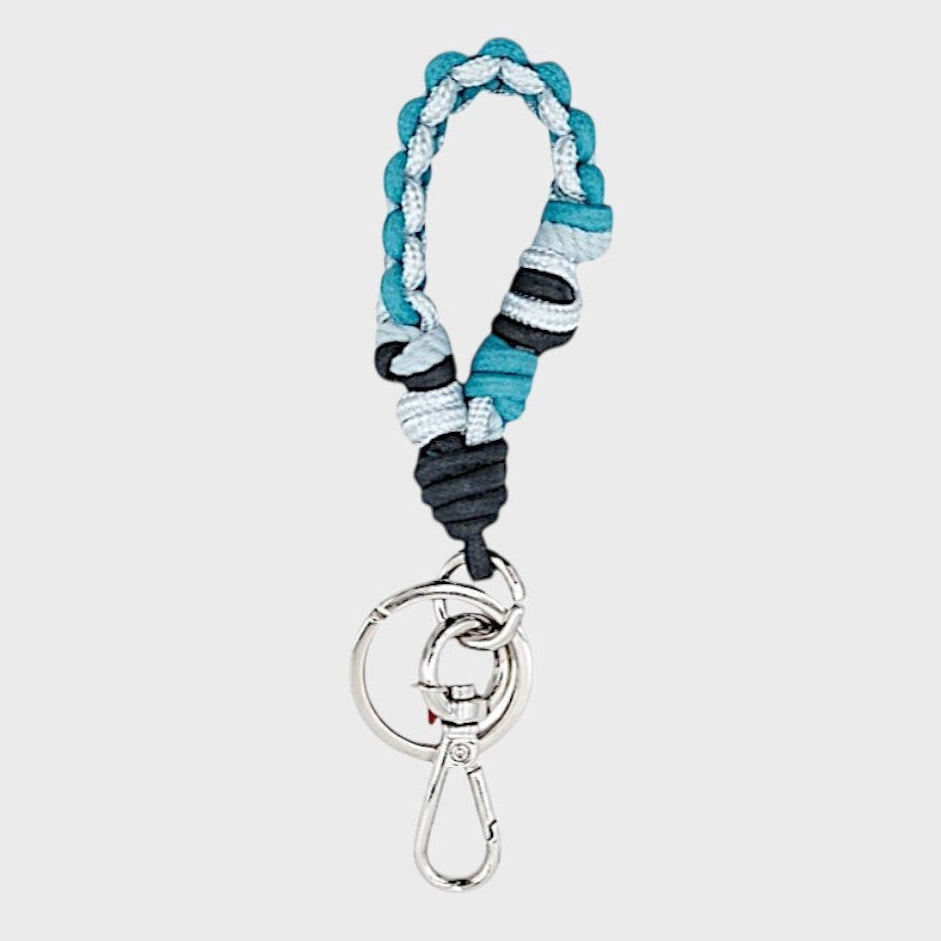 A braided macramé keychain or bag clip in dark and light blue, featuring a silver metal clasp.