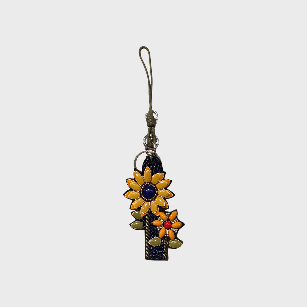 An embroidered bag charm with yellow flowers and blue details.