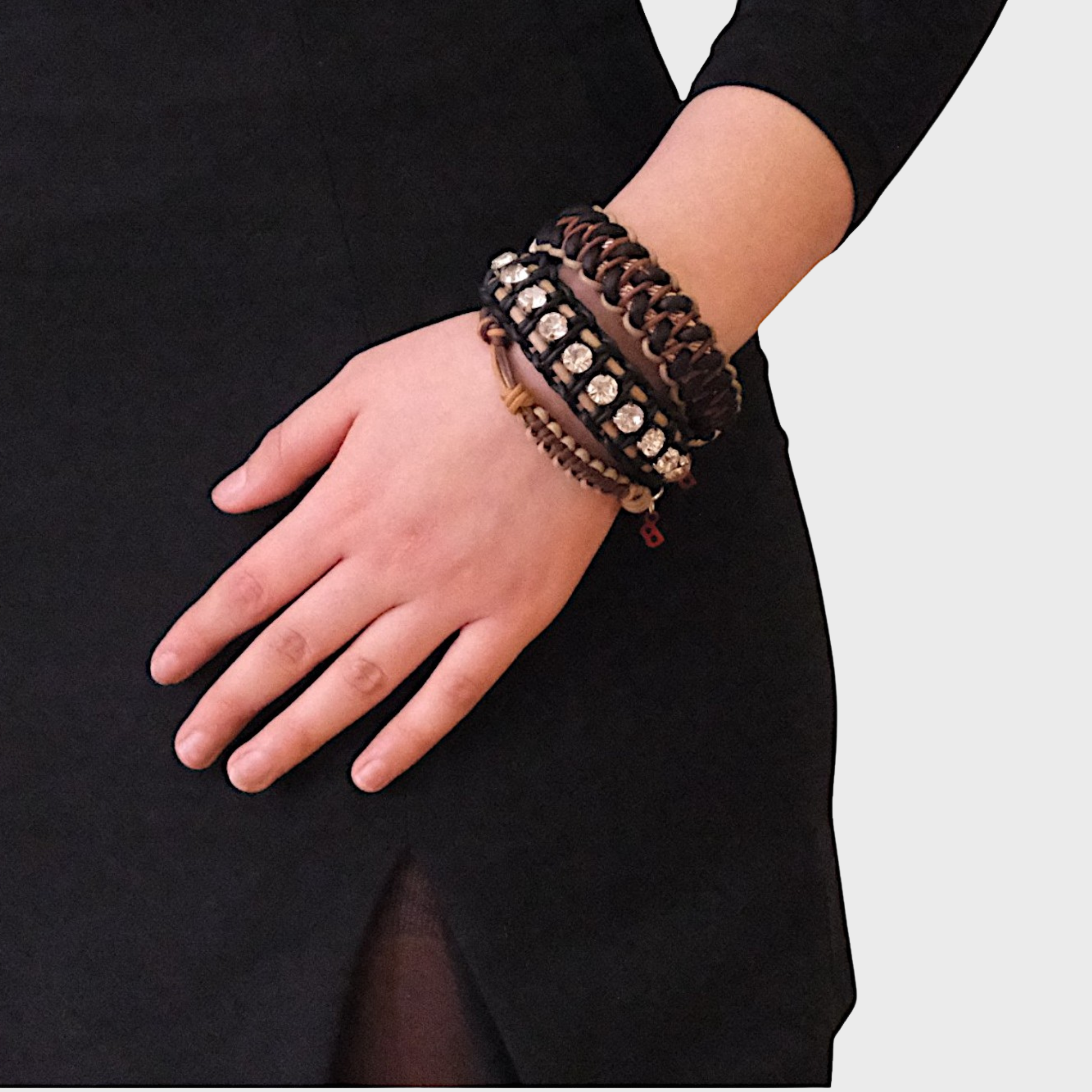 A model wearing several bracelets including the brown and beige Nino bracelet
