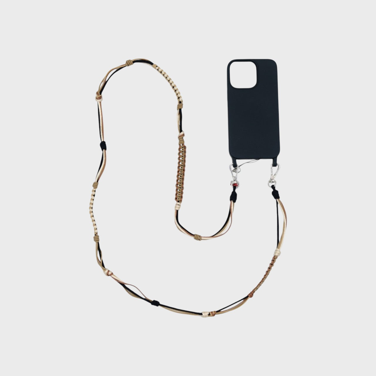 Brown, beige and black macramé woven phone lanyard with a black phone case on a white background.