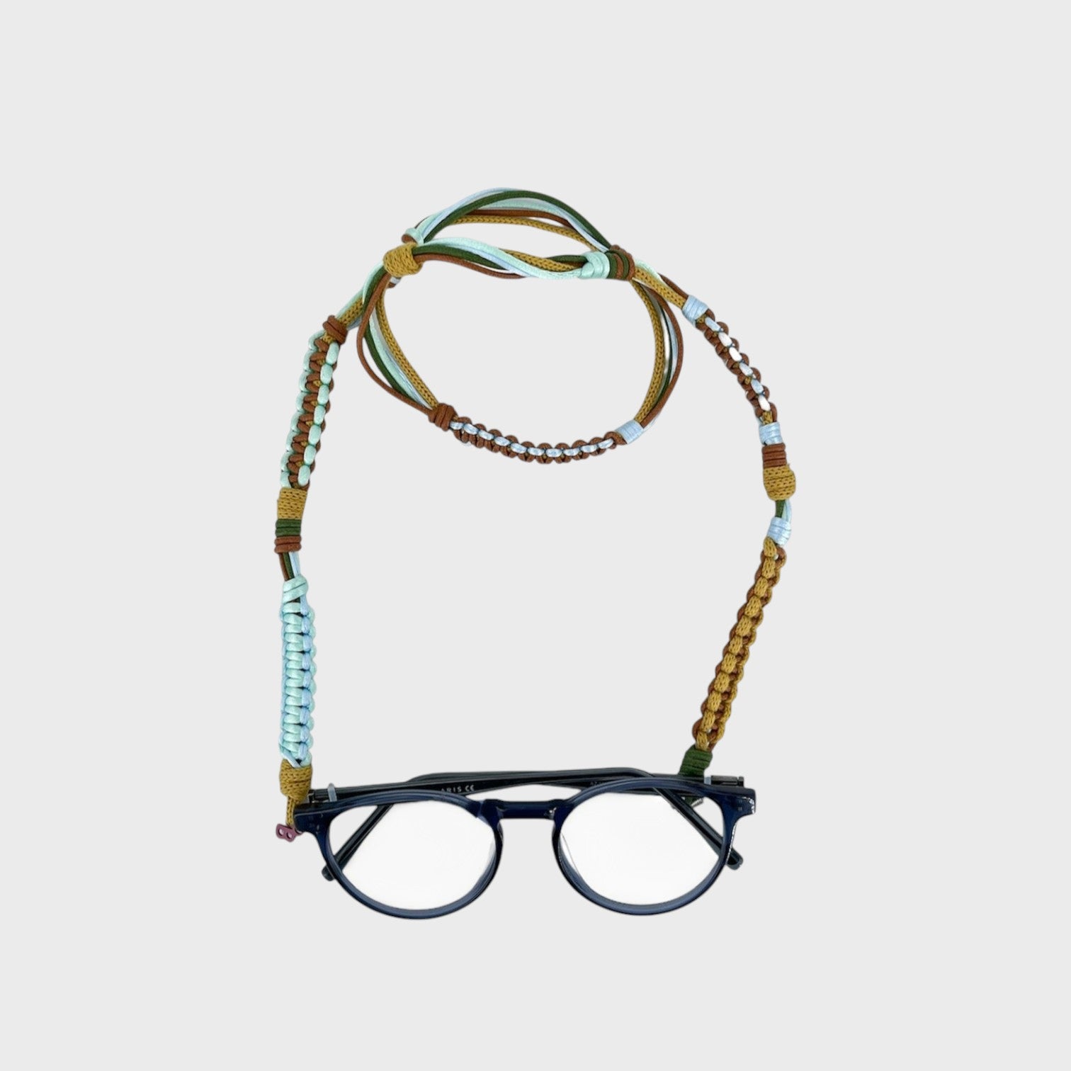Woven eyeglass holder with khaki, brown and bright light blue details on a white background