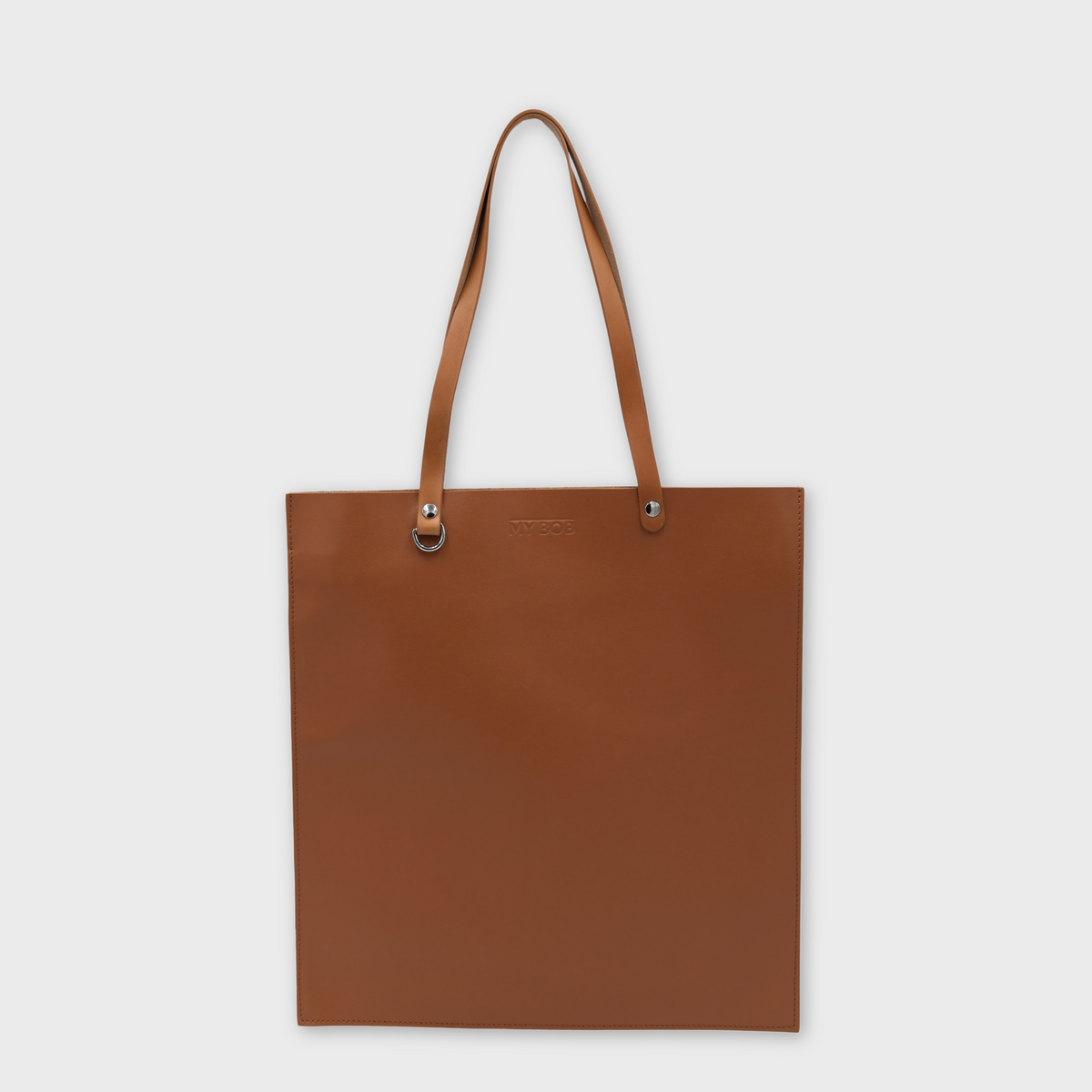 A brown leather tote bag with matching shoulder straps and small silver-tone metal hardware, centered on a light gray background.