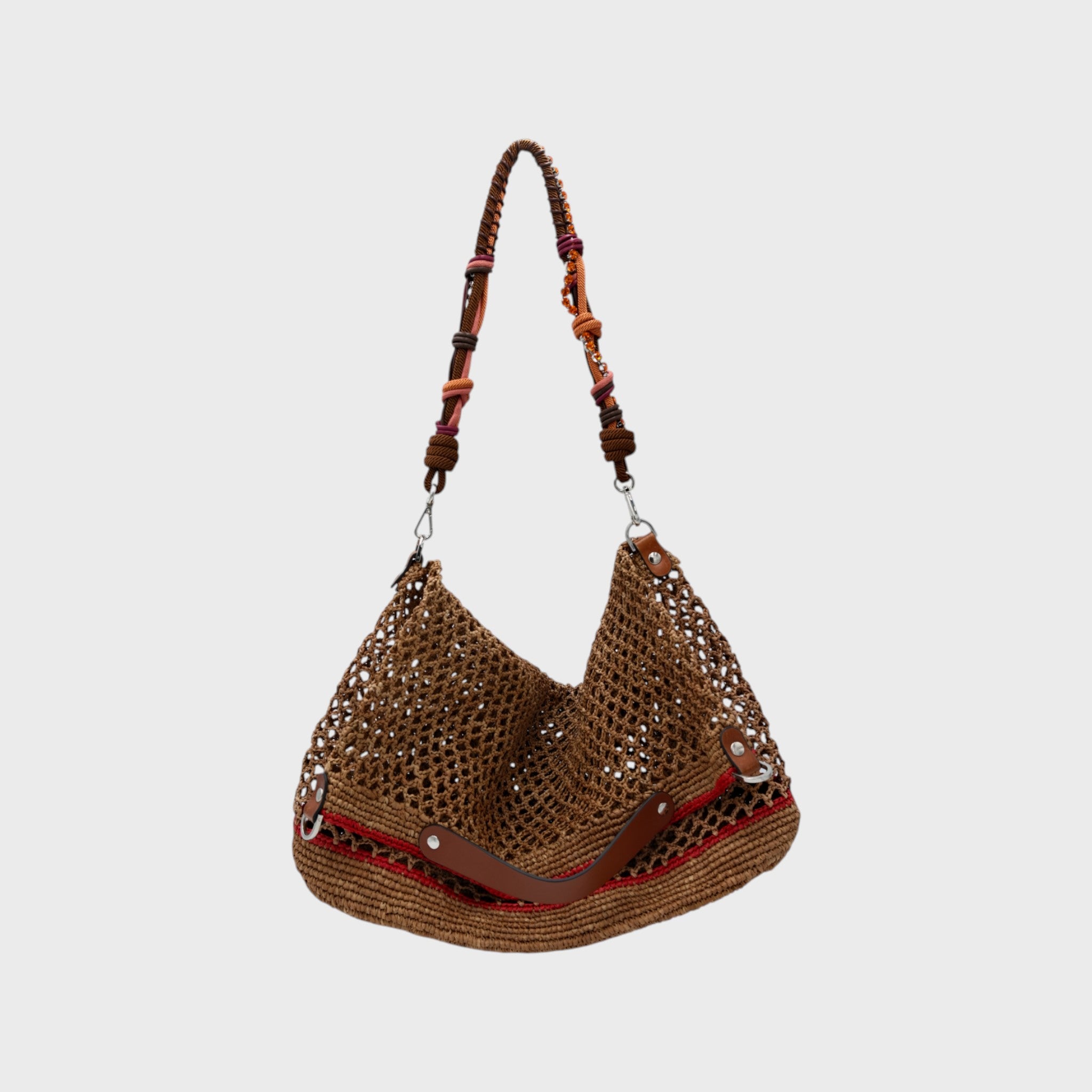 A Brown raffia Colin Tote Bag with red stripes, hanging by a brown, pink and orange and small orange stones beaded bag strap.