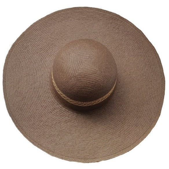 A brown raffia wide-brimmed hat shot from above.