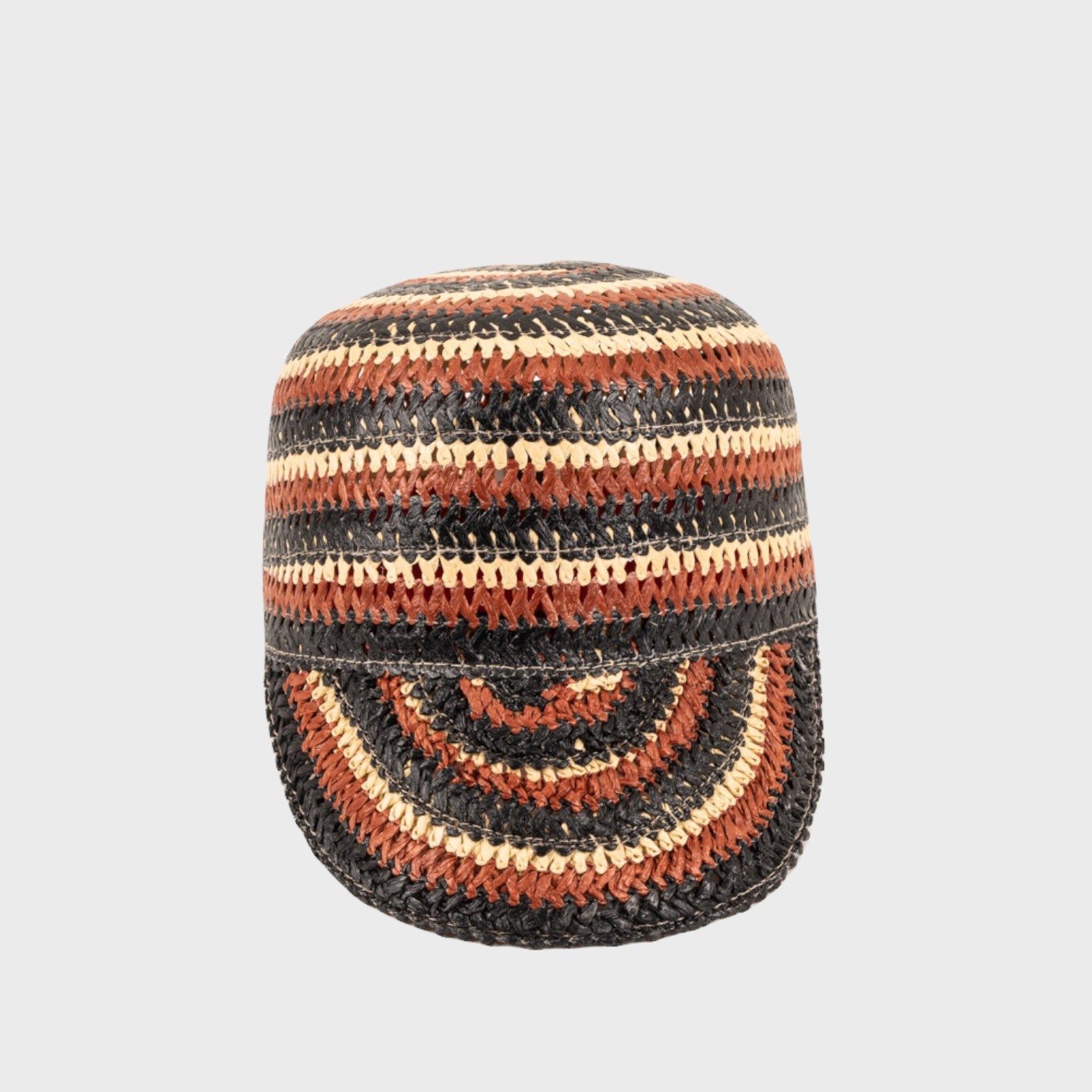 A brown, beige ancd black striped raffia cap on a light grey background facing the camera.