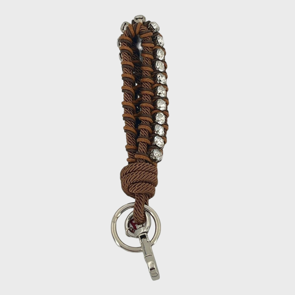 Brown mracramé braided keychain with silver beads and clasp on a white background