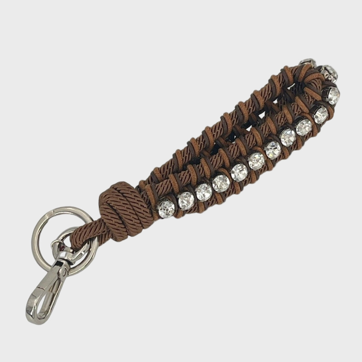 A brown macramé braided keychain with silver rhinestones.