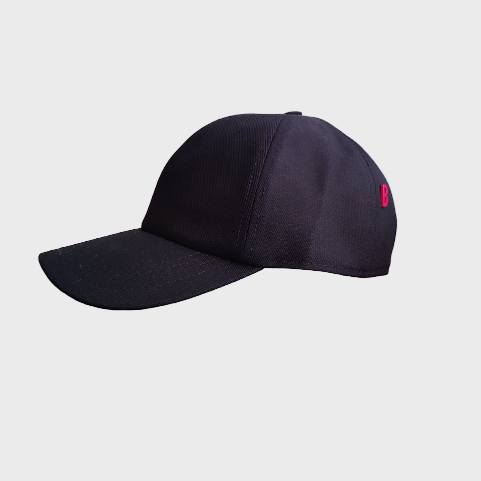 A dark blue cotton baseball cap on a light grey background.
