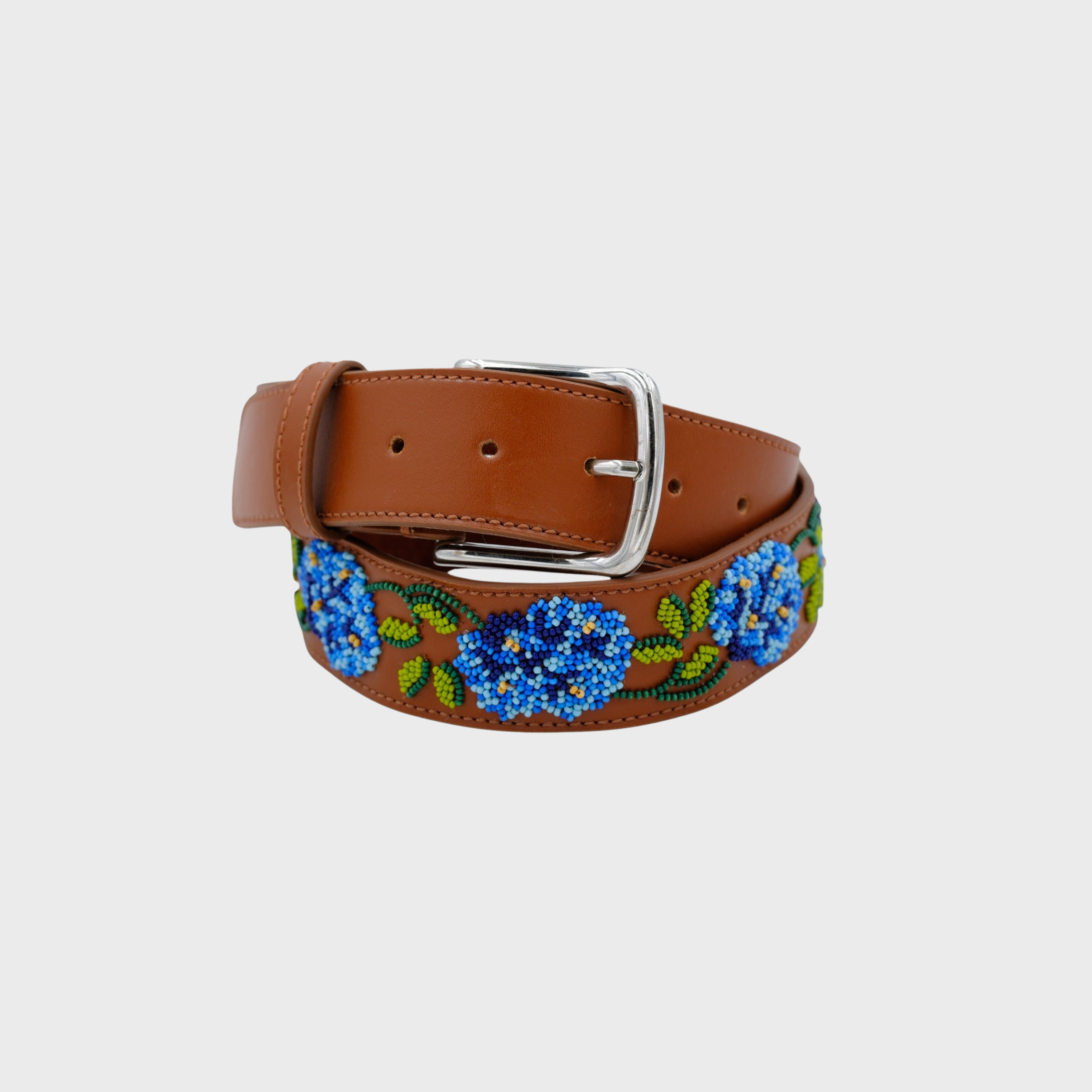 A brown leather belt with a silver buckle, decorated with blue and green beaded floral patterns along the strap.