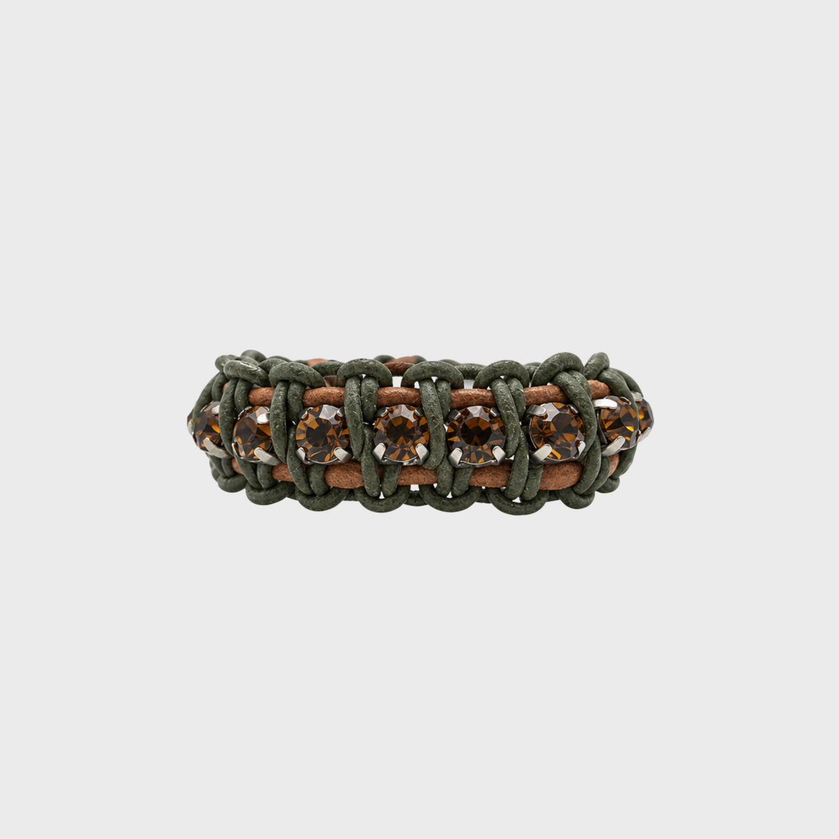 A handmade macrame bracelet featuring olive green cord, brown leather, and brown faceted crystals on a light gray background.