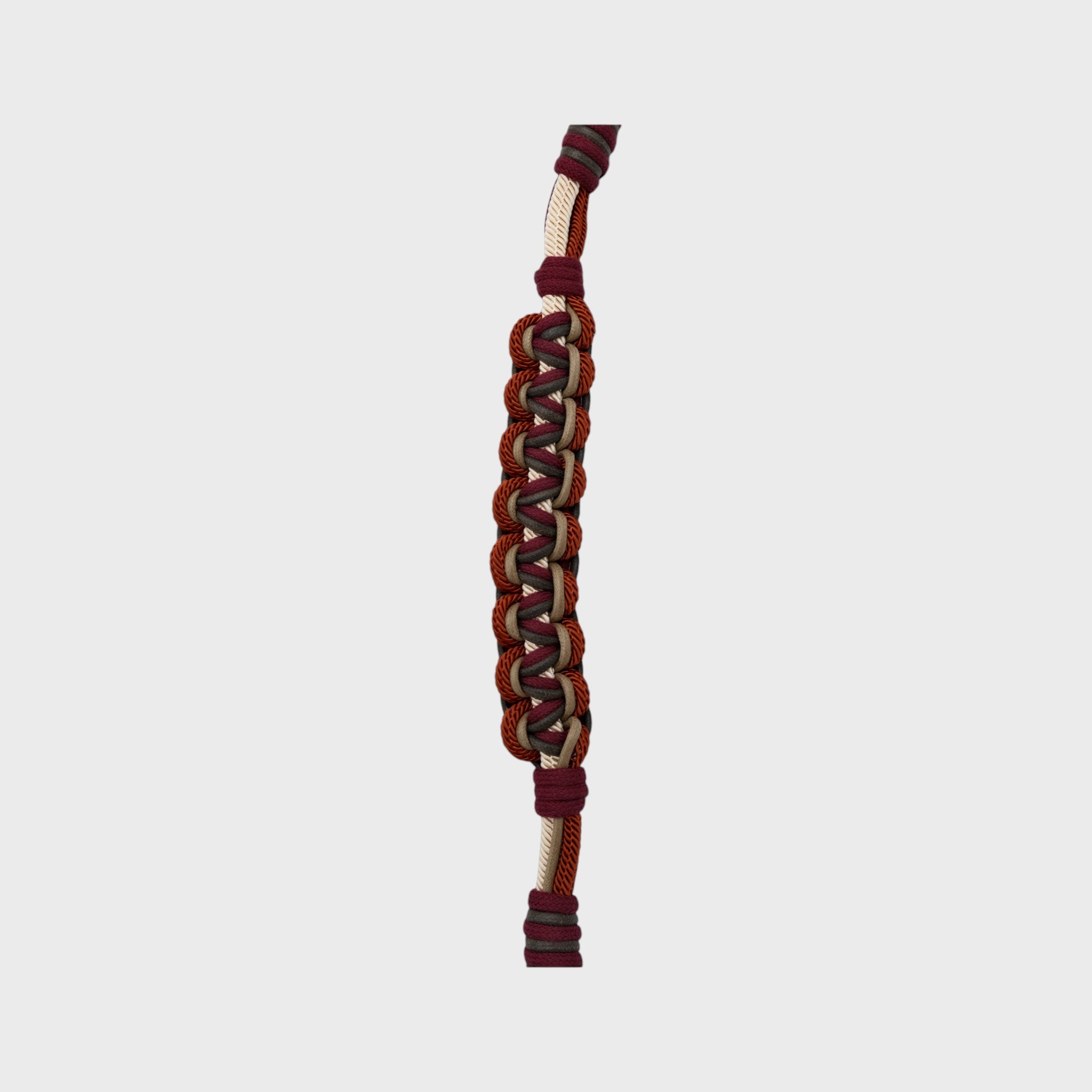 Multicolored braided macramé bag strap in beige, dark red, and dark green with metal hooks on a light gray background.