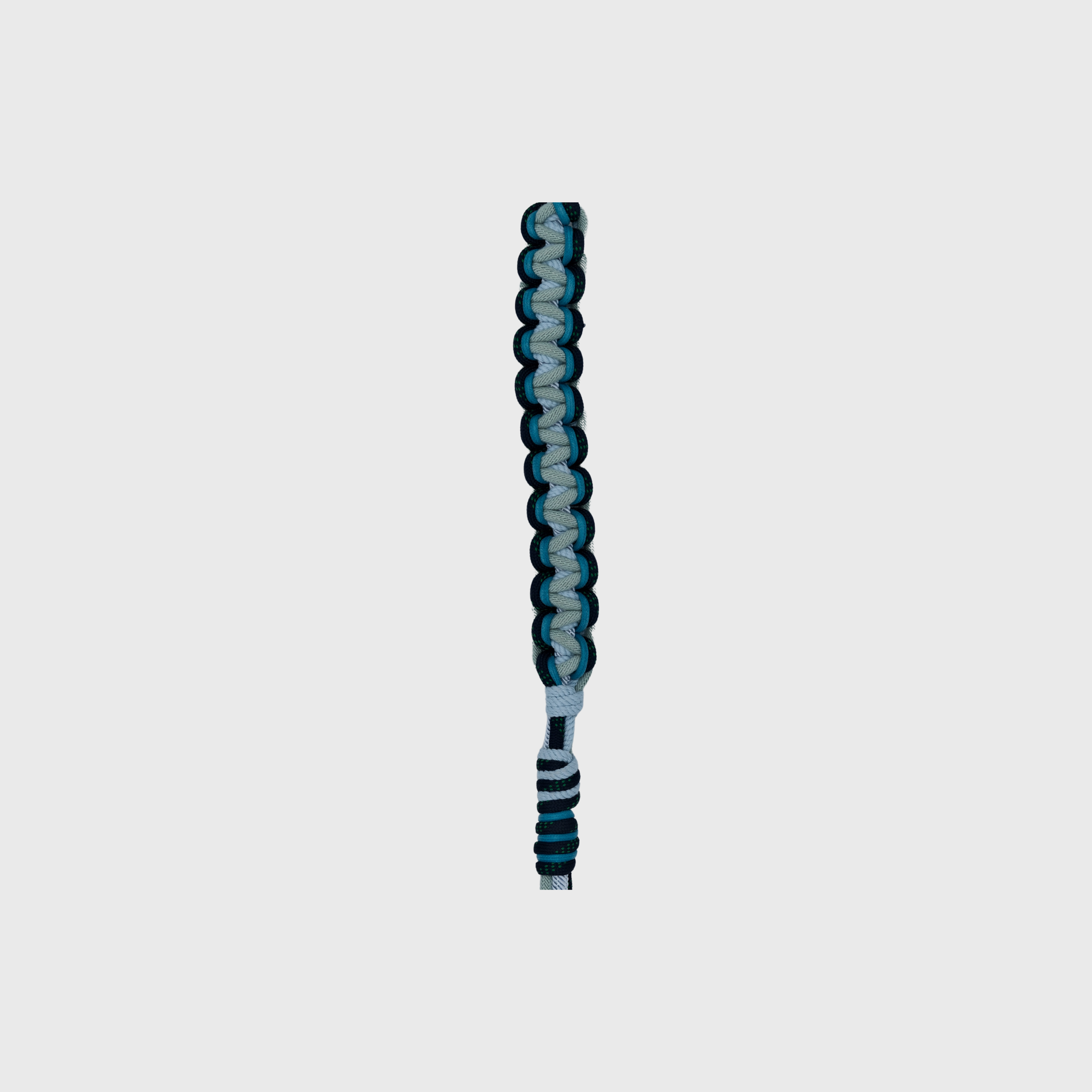 A detail shown of the braided macramé bag strap with a light blue and dark teal pattern, featuring silver metal snap hooks at the ends.
