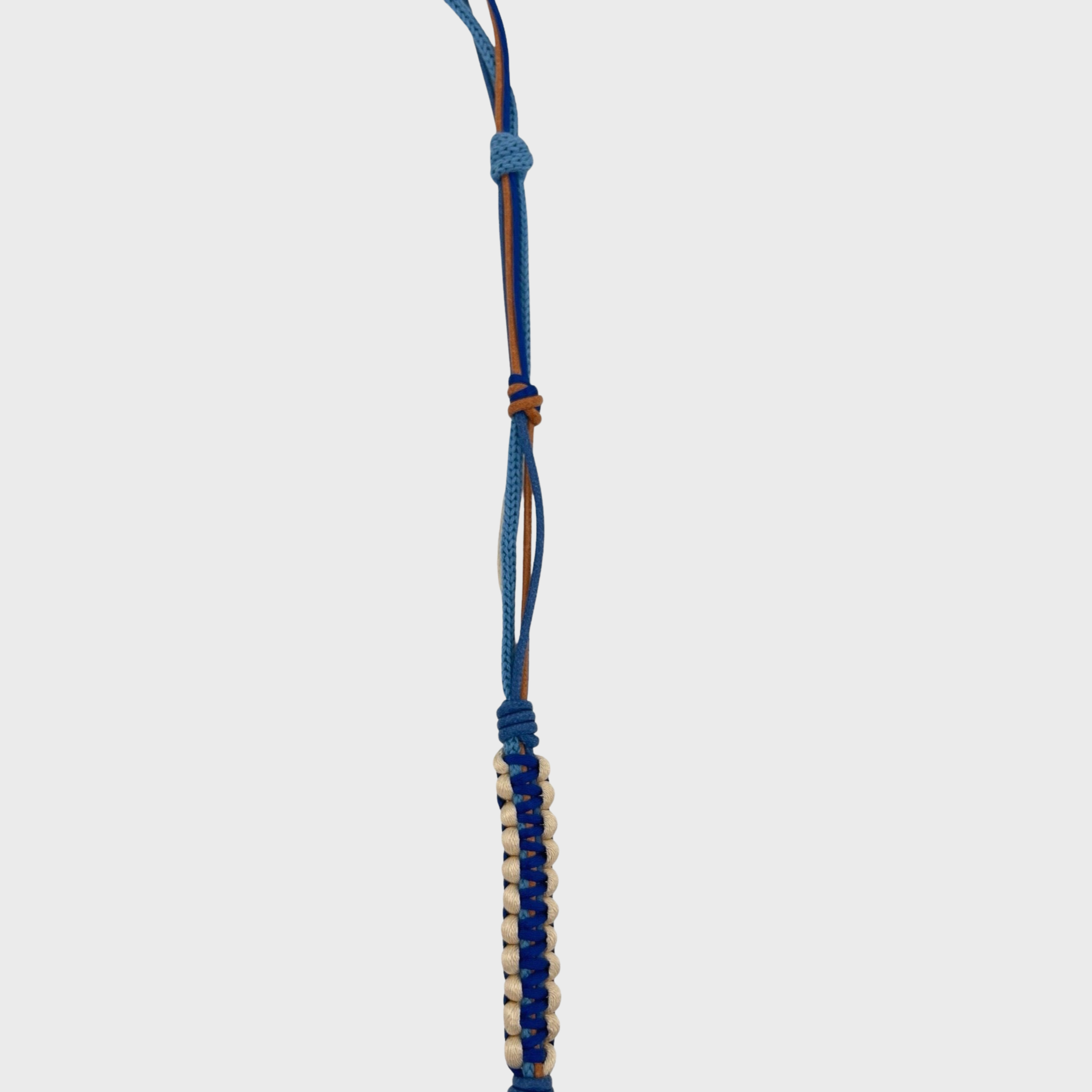Detail of the beige, brown, blue phone lanyard.