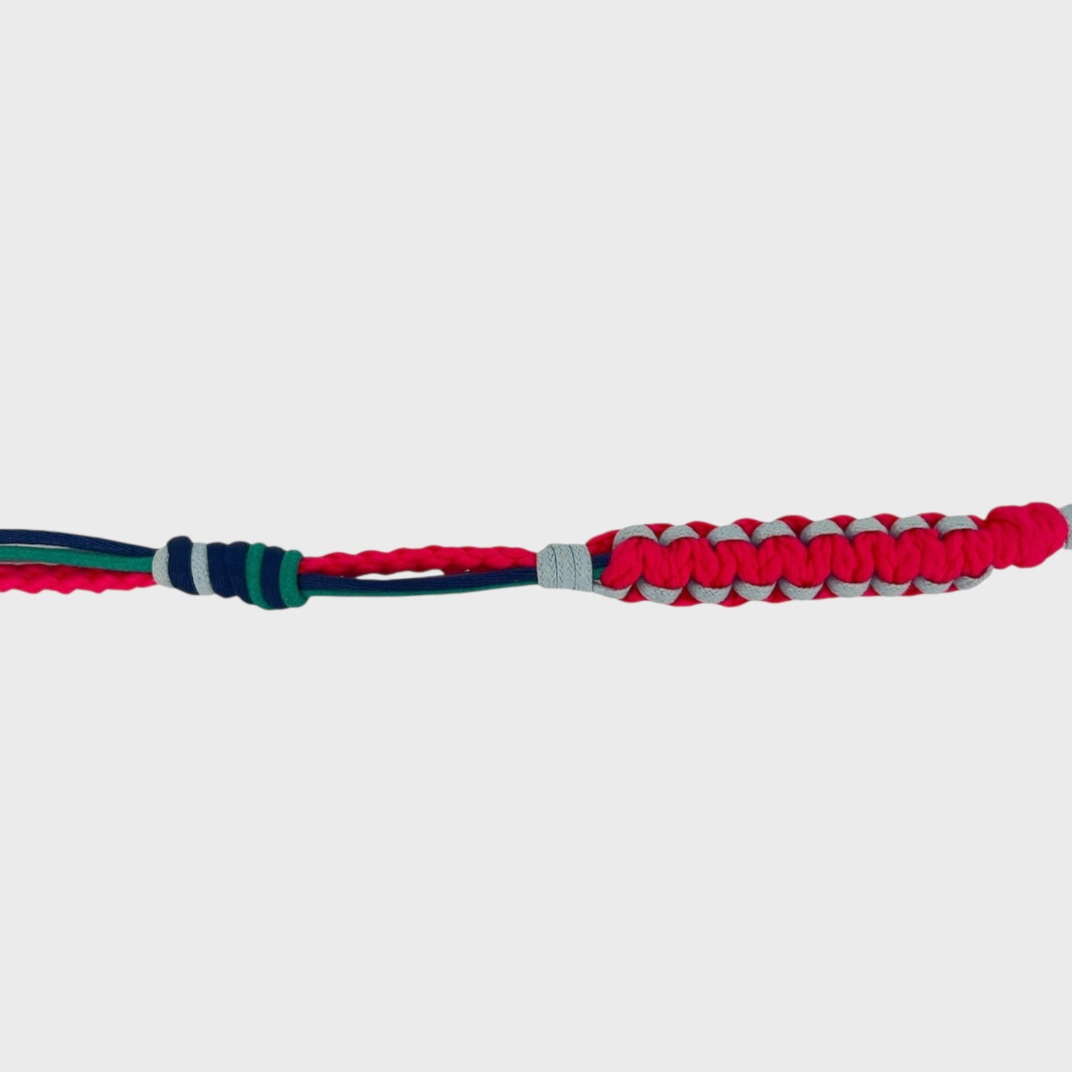 Eyeglasses holder with pink, blue, and green woven pattern on a white background