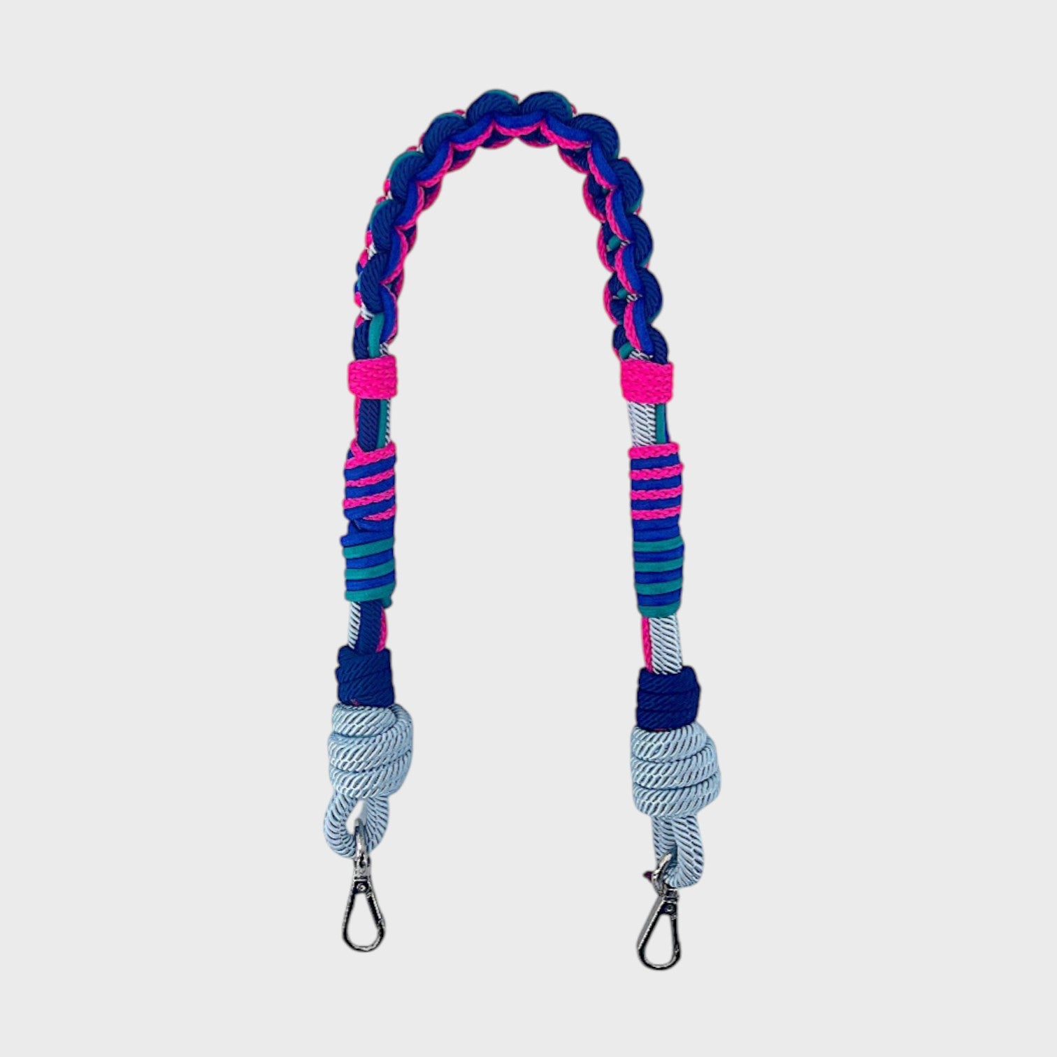 Multicolored braided macramé bag strap in bright pink, bright blue, and light blue with metal hooks on a light gray background.