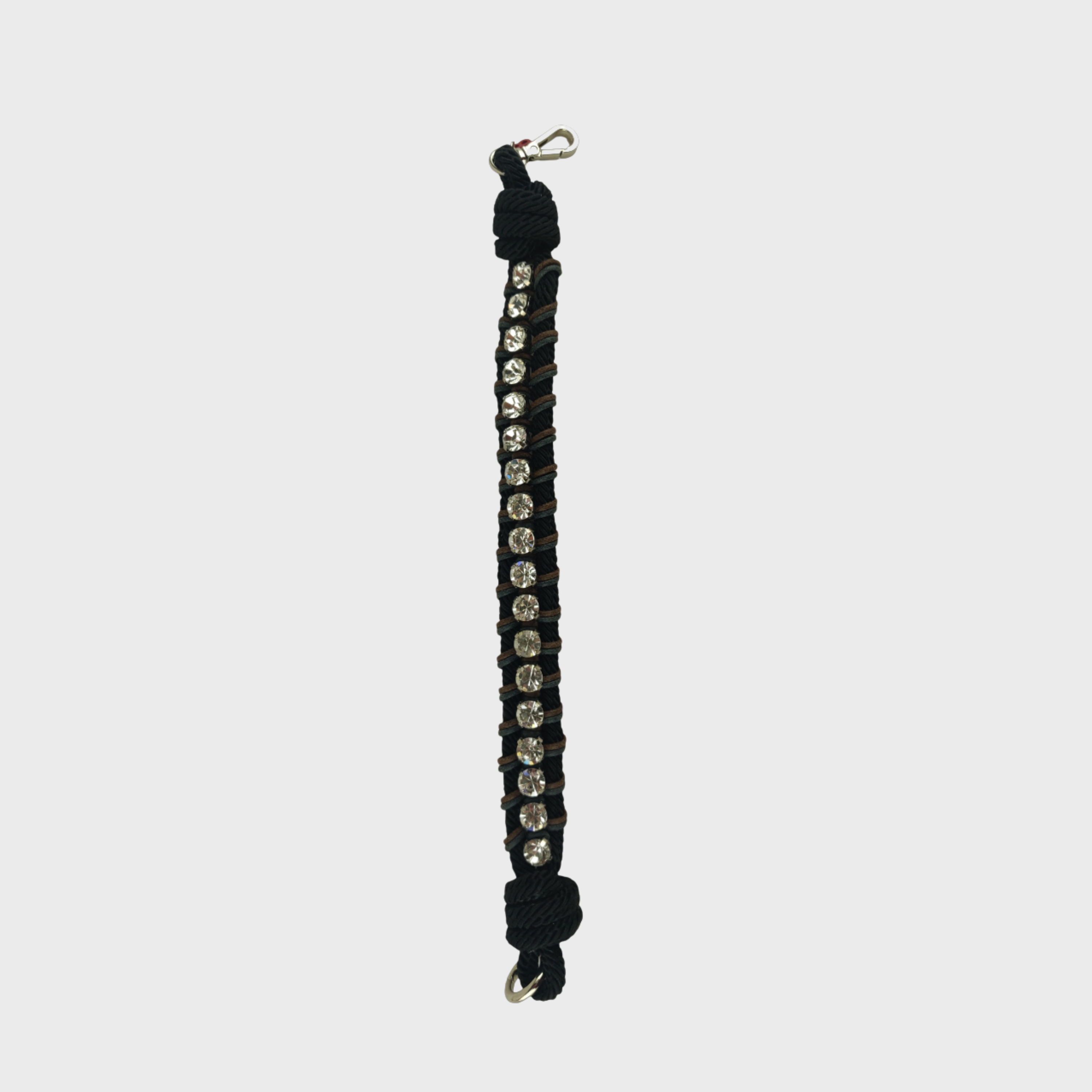 A braided macramé collar featuring black, blue and green cords with small diamond beads and a silver clasp laid flat on a light grey background.