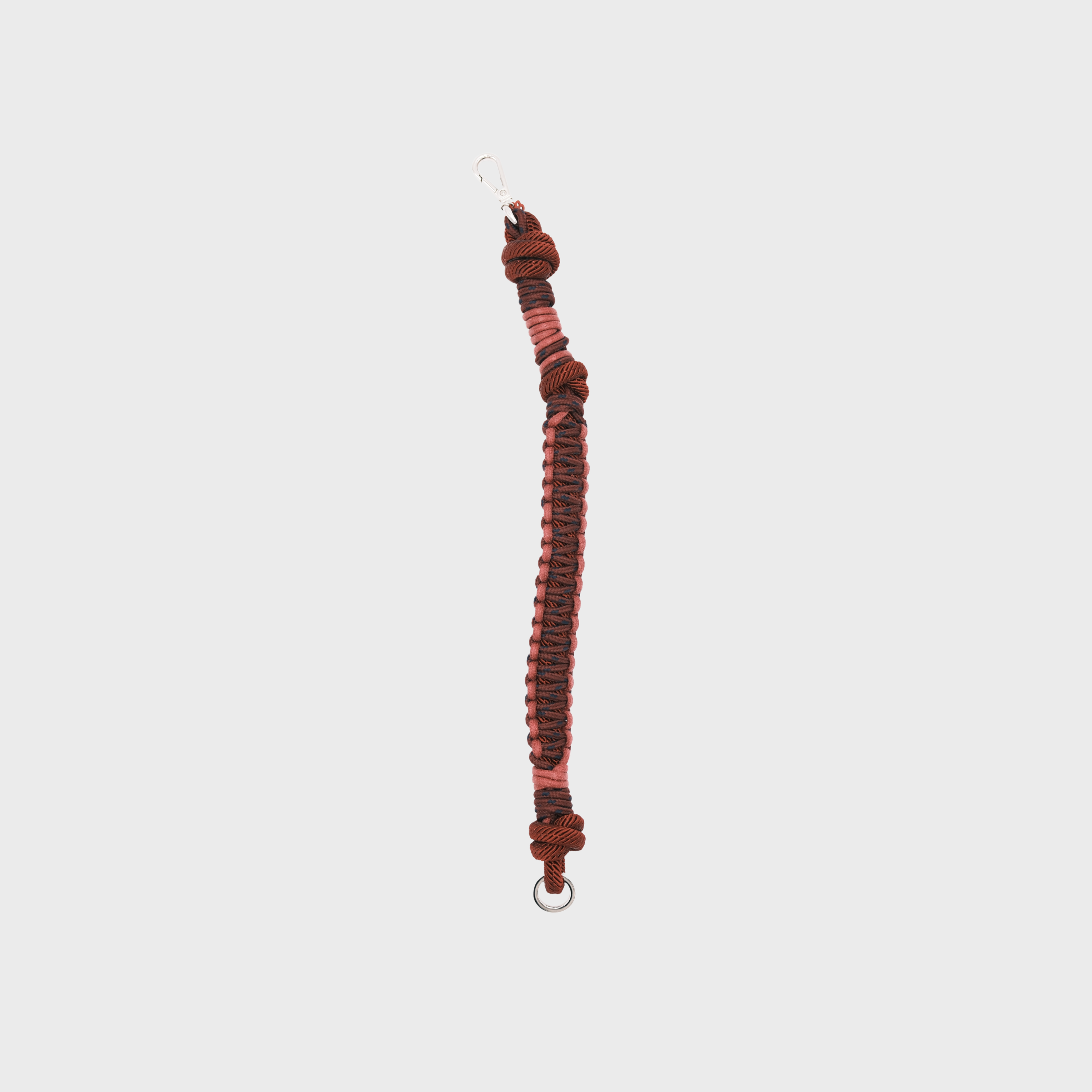 A red and pink braided dog collar with light blue knotted accents and a metal clip