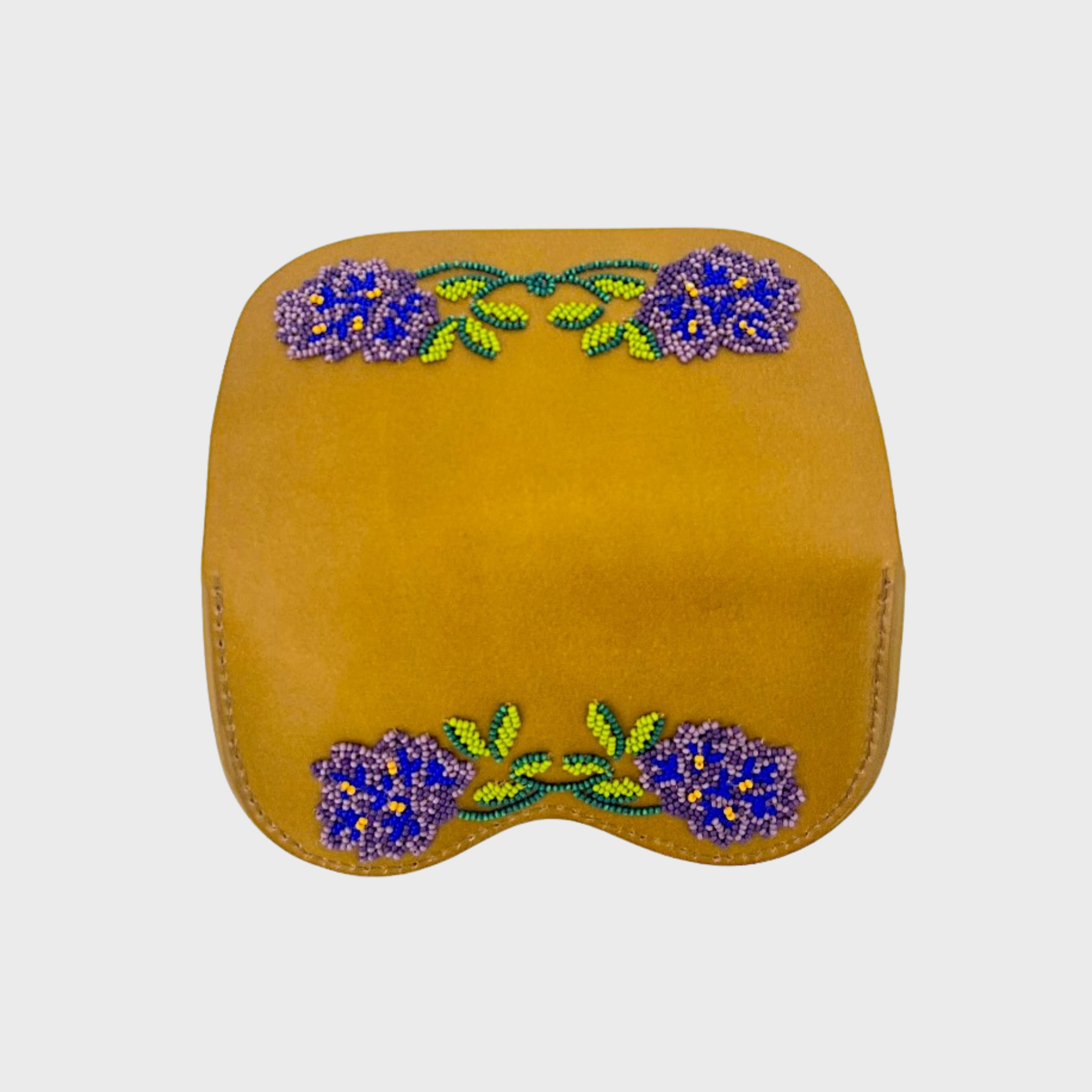 A mustard yellow leather glasses case opened , featuring decorative beaded floral embroidery in purple and green on the front, set against a plain light gray background.
