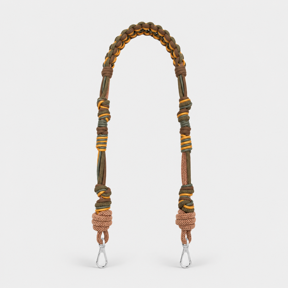 Brown and green woven bag strap with metal clips on a light gray background