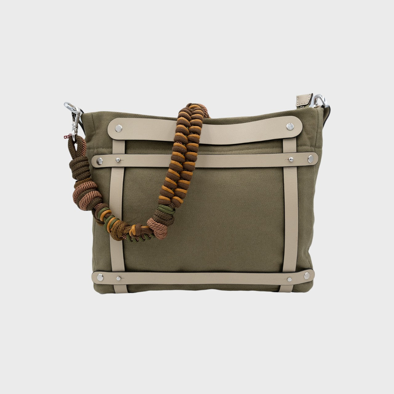 Multicolored braided macramé bag strap in dark green and brown, shown on a green cotton Minopti bag.