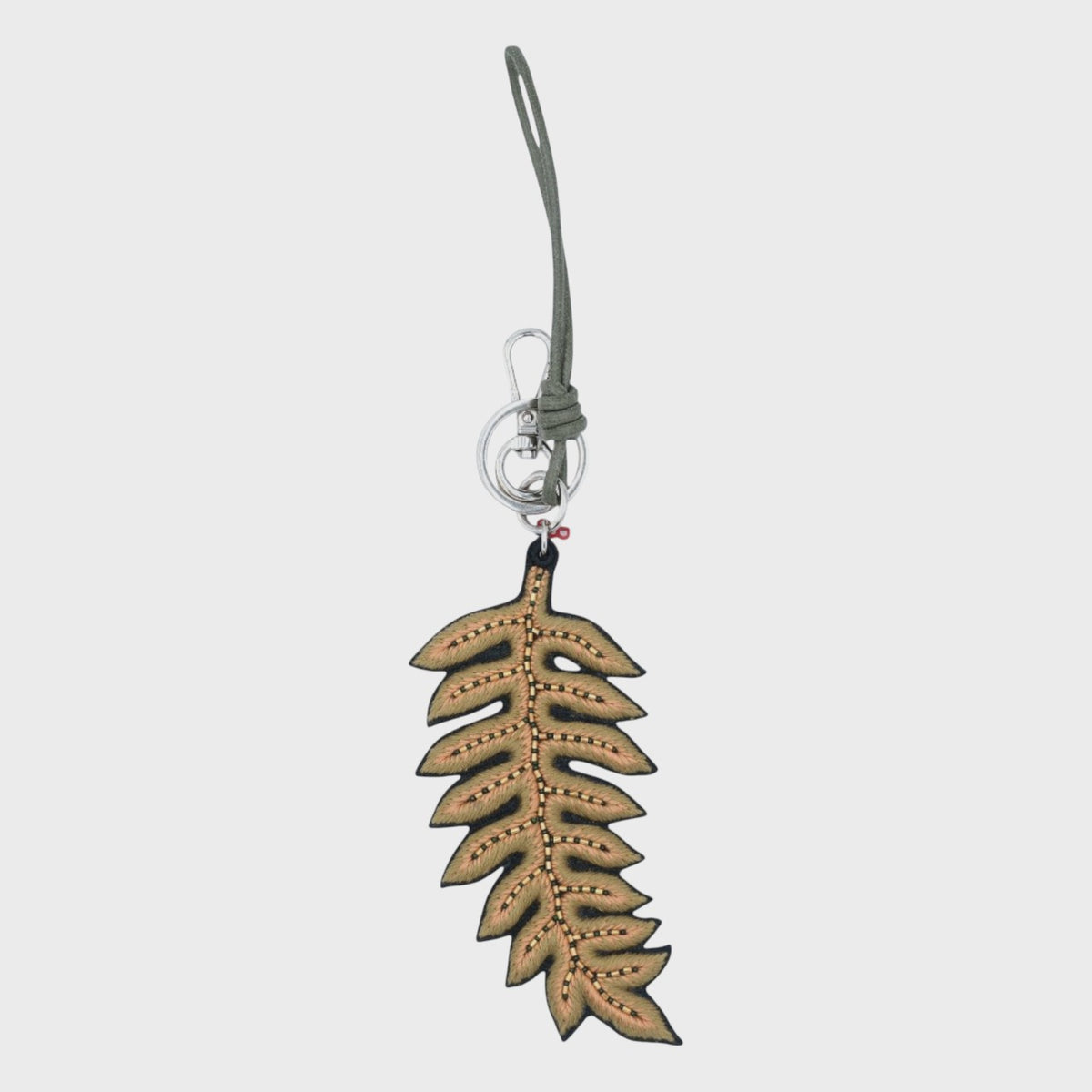 An embroidered green Leaf-shaped keychain on a light gray background