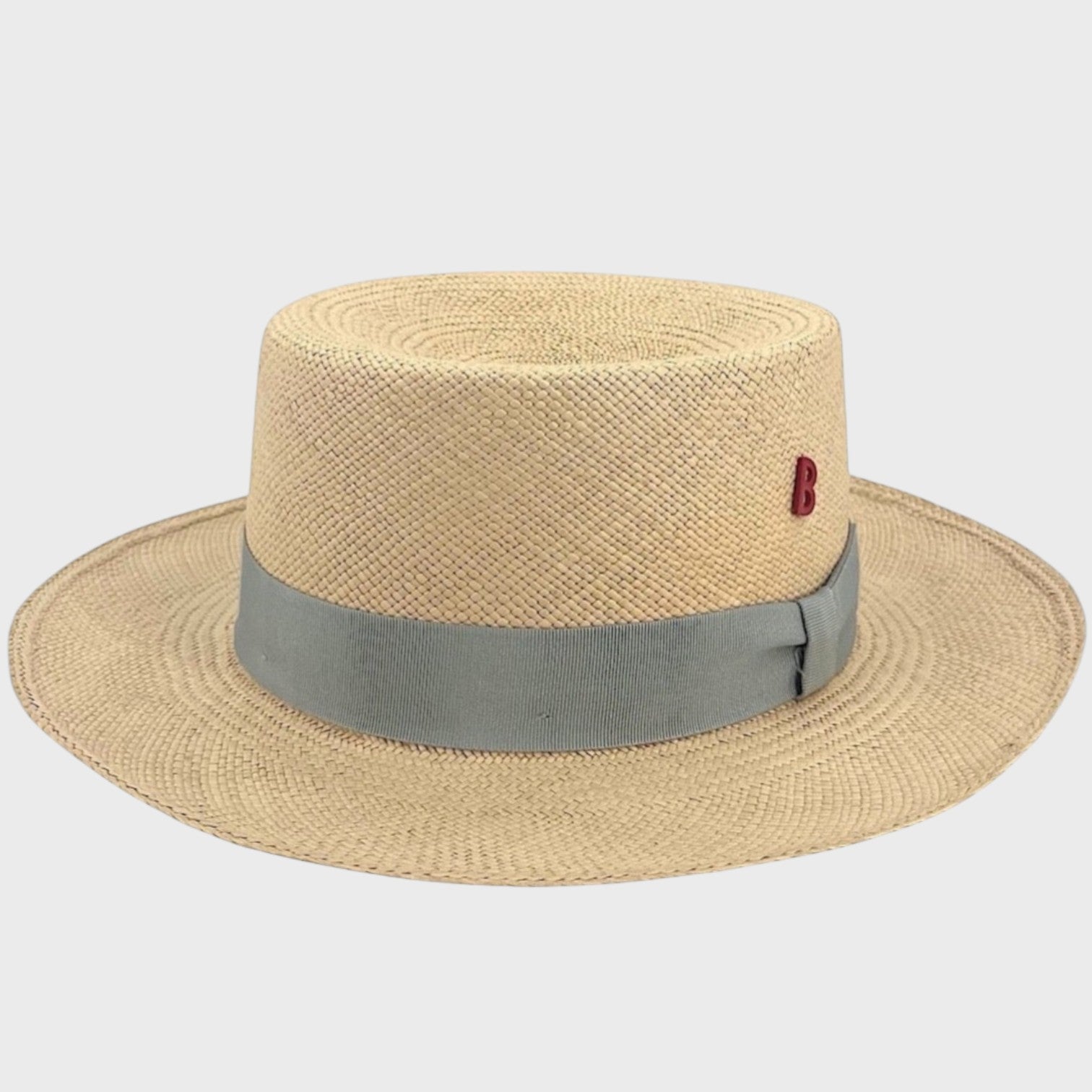 A beige straw fisherman hat with a grey ribbon around it.