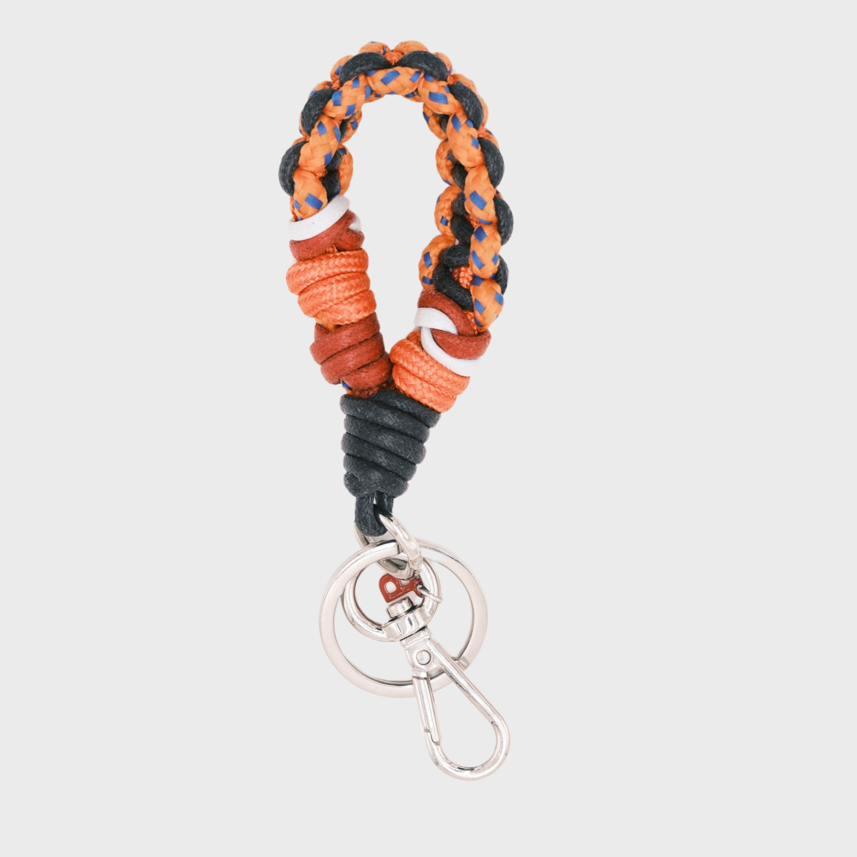 A braided macramé keychain or bag clip in neon orange, red and black, featuring a silver metal clasp.