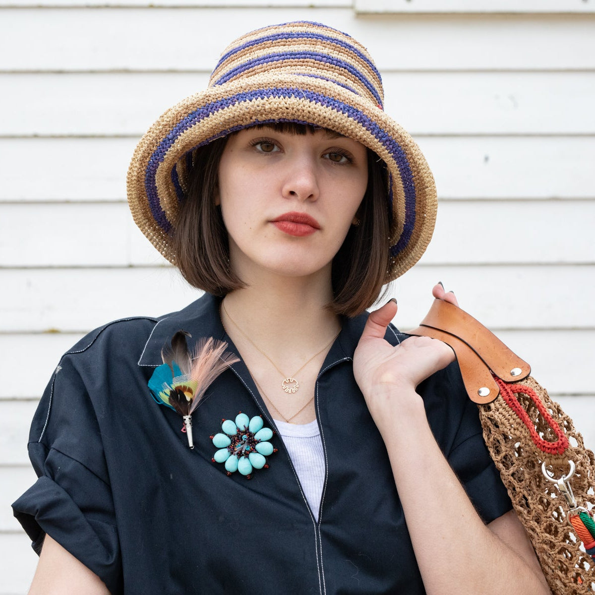 A model wearing the blue Ixia flower brooch.