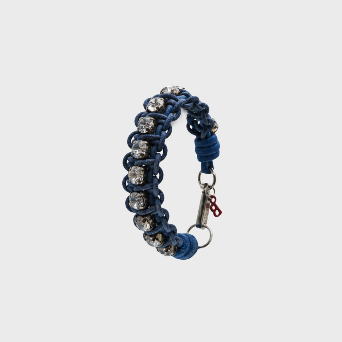 A braided macramé bracelet featuring blue cords with small white beads.
