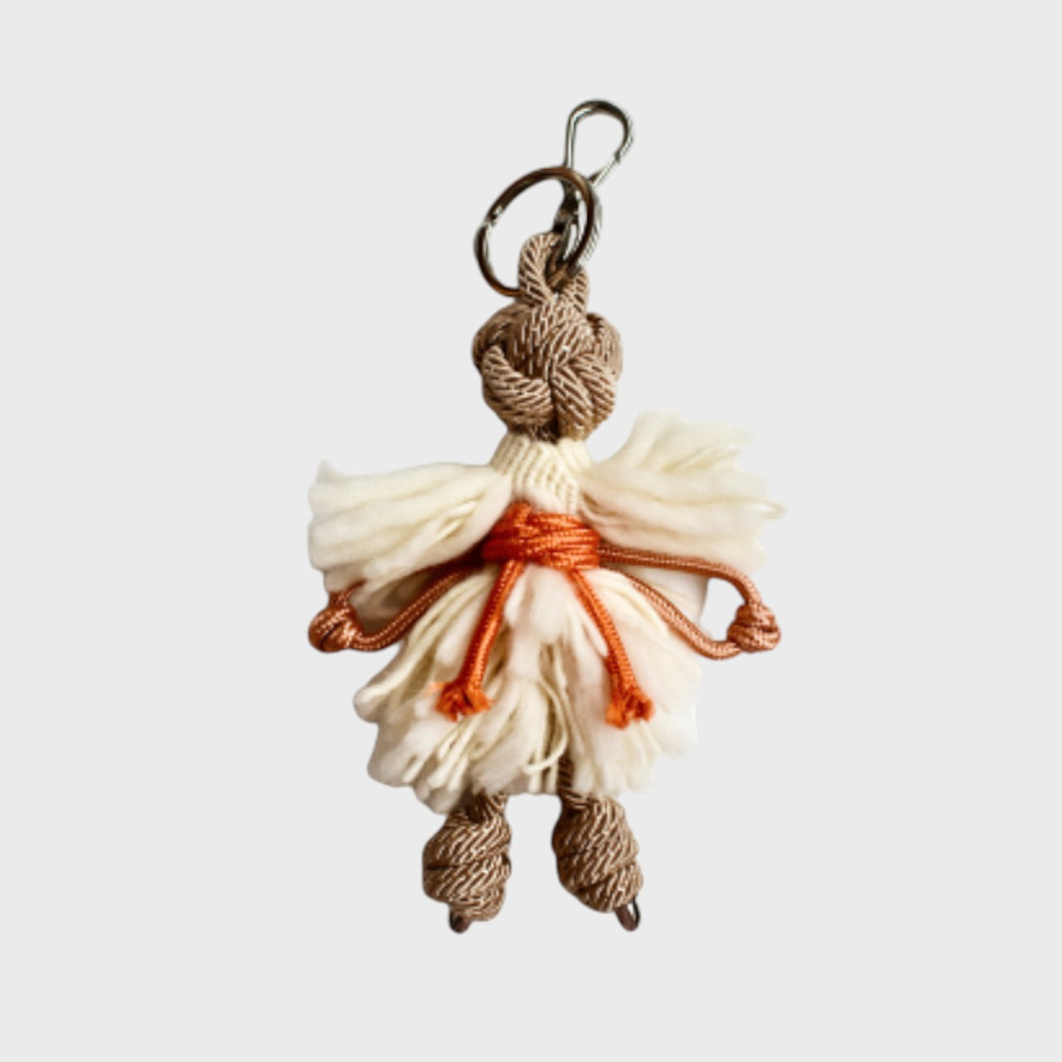 Decorative keychain with a fluffy character design on a light gray background