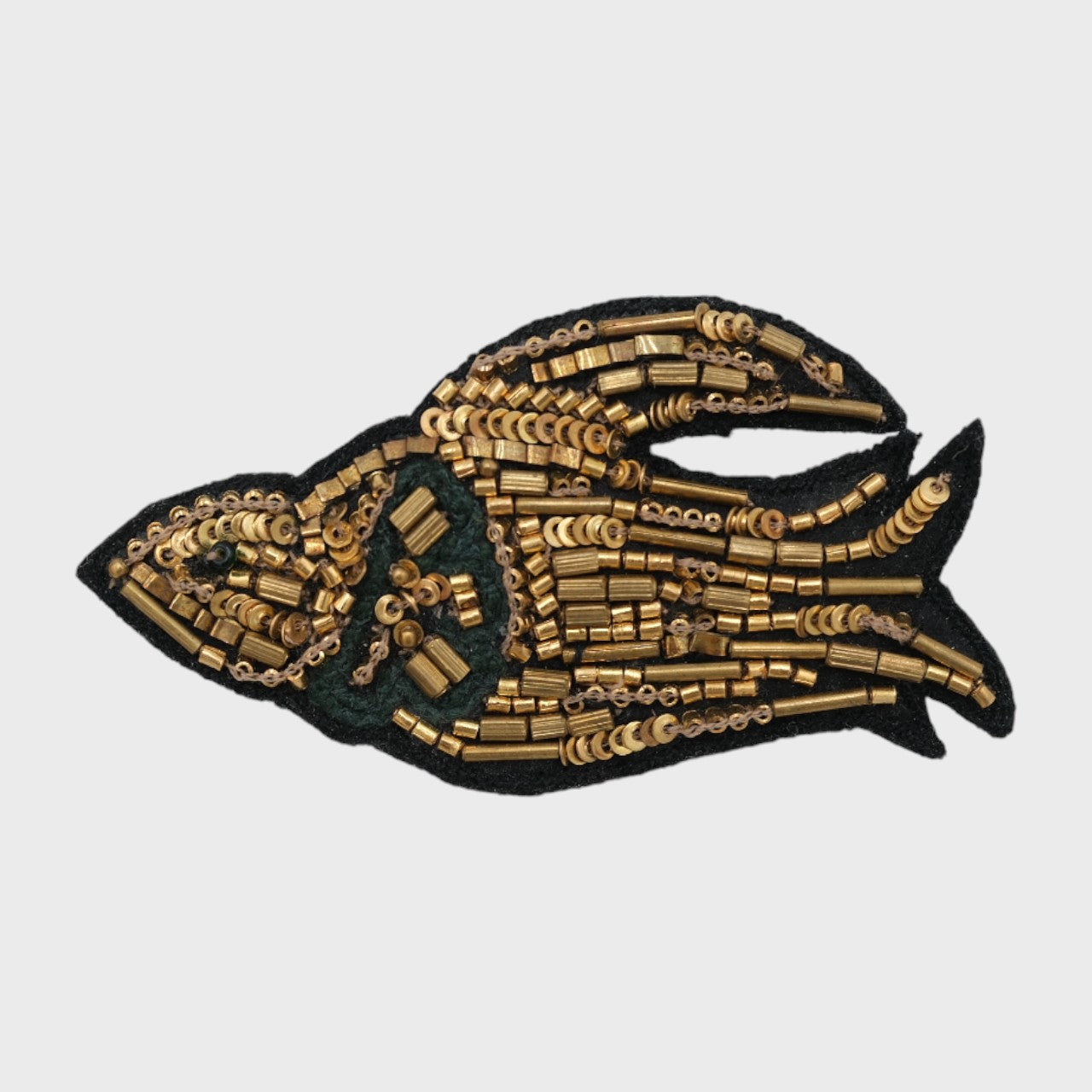 An embroidered brooch representing a golden bird.