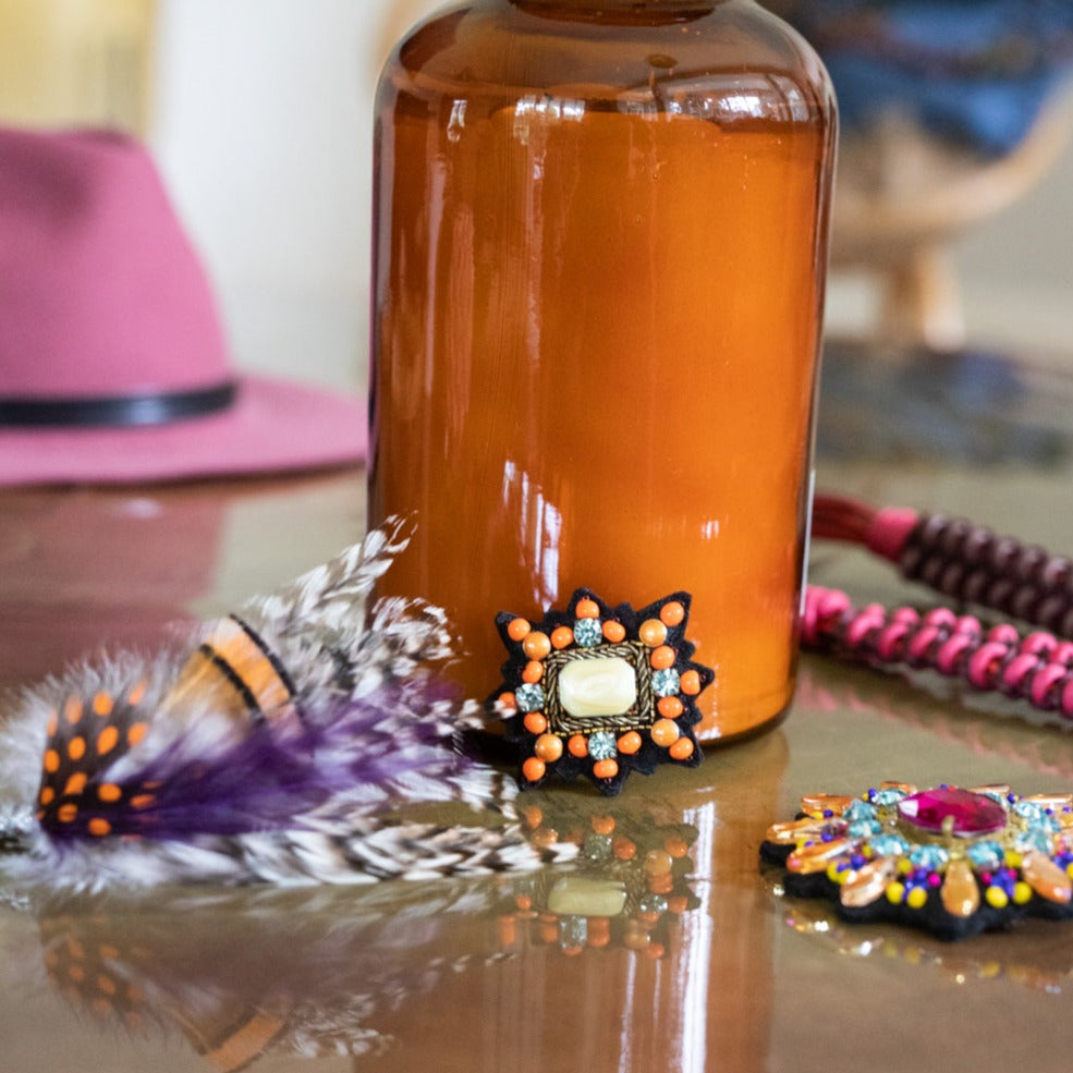 The orange Mizar star brooch exposed with several other brooches.