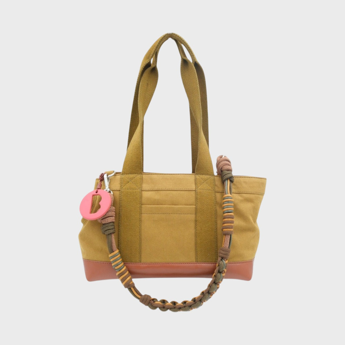 Mustard dog bag with a braided strap on a white background