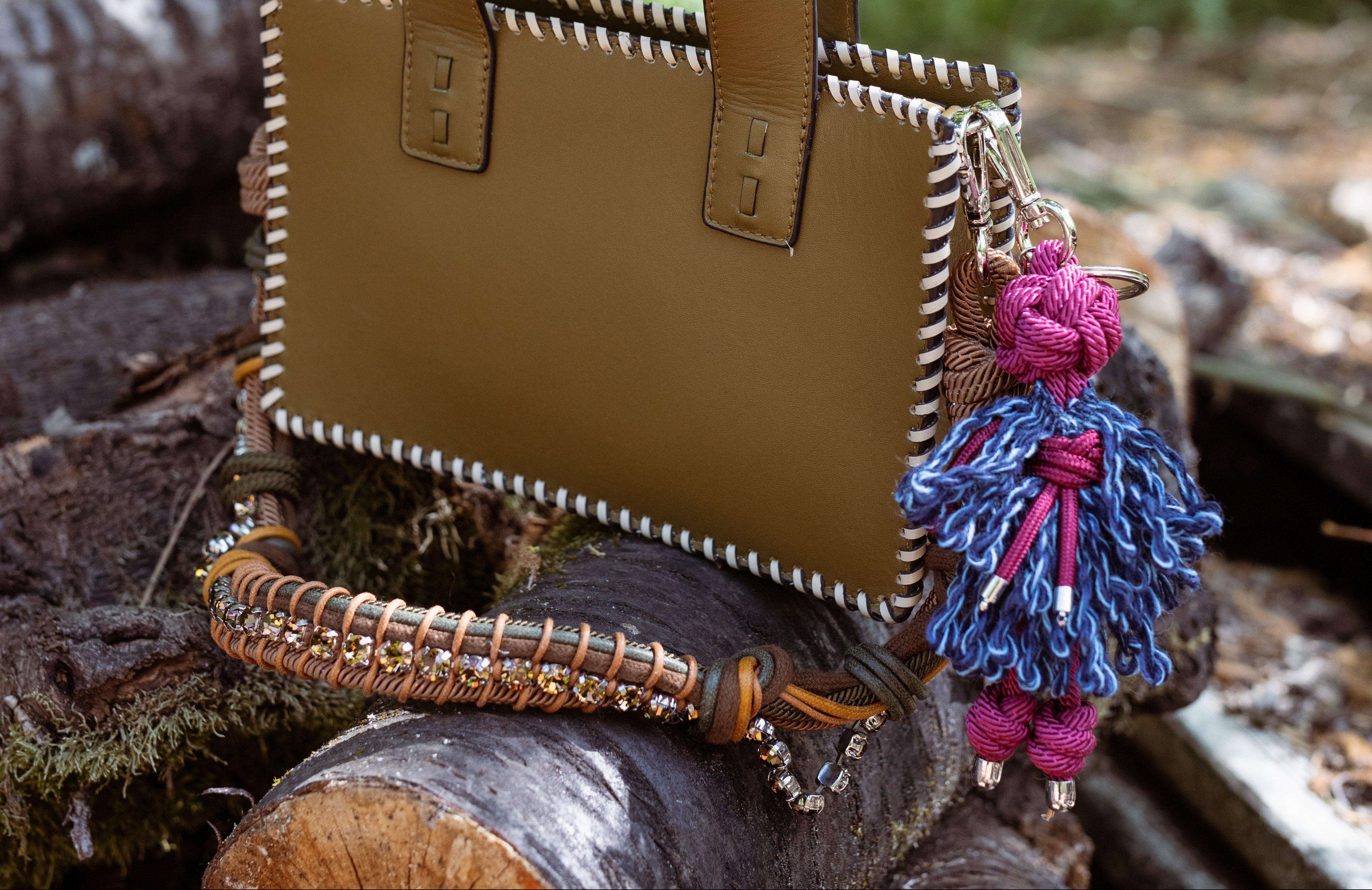 The green Maori Handbag on trees with the green and brown strap.