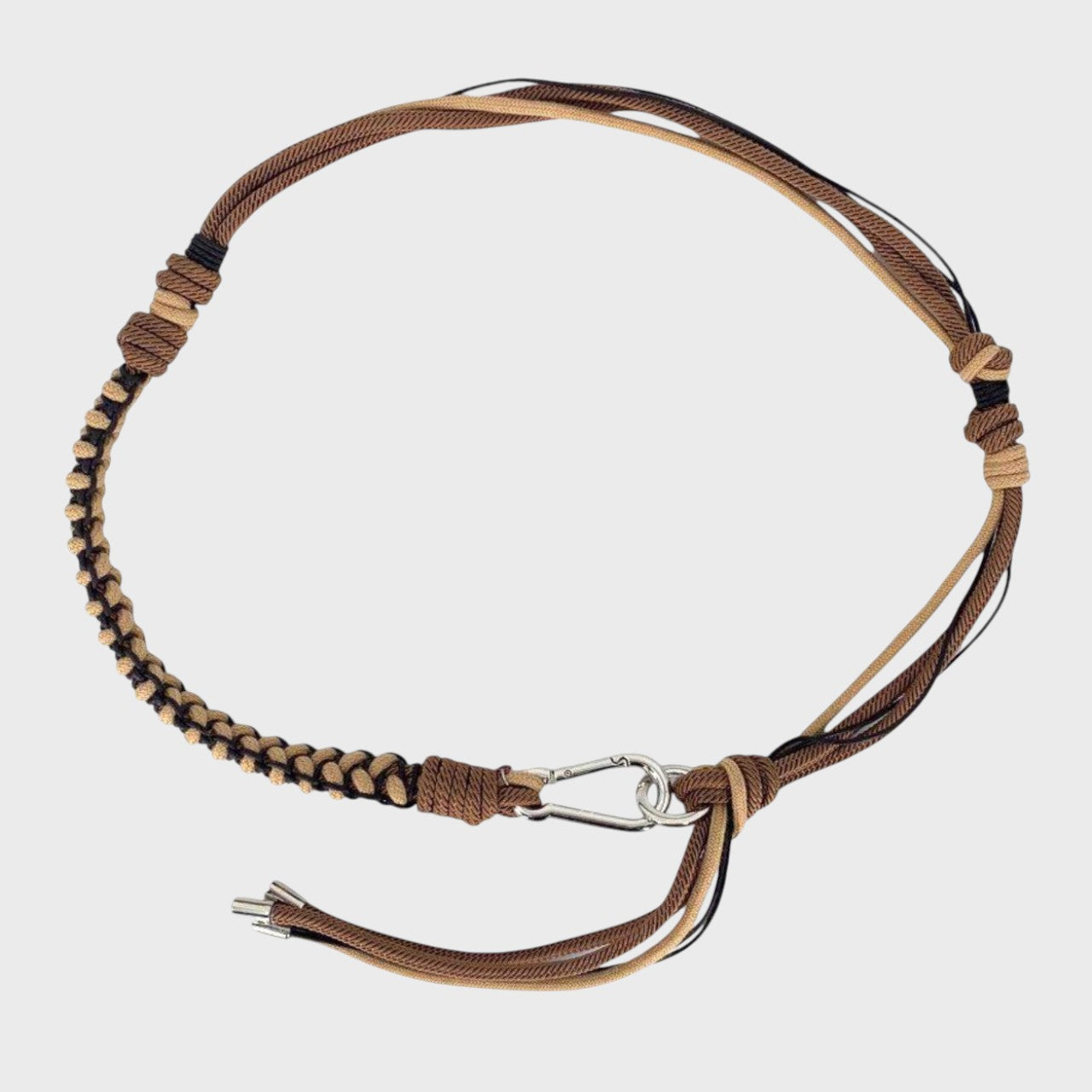 Brown, black, and beige handmade macramé belt with a silver clasp.