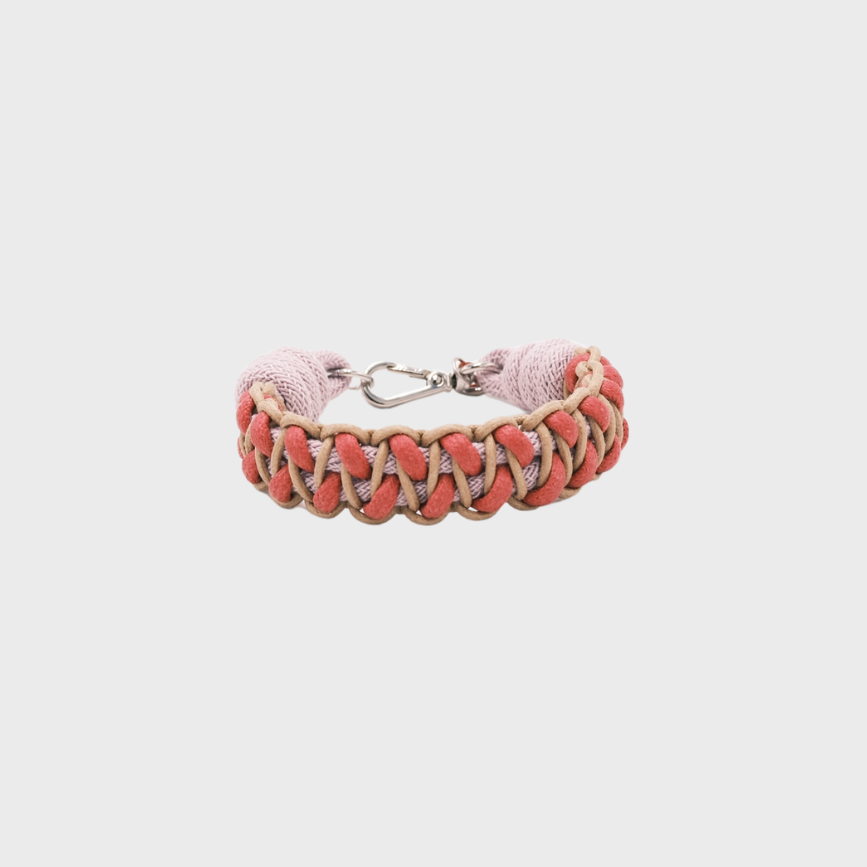 A braided leather and cord bracelet with shades of bright pink, light pink and beige. It ends and a silver clasp, shown on a light gray background.