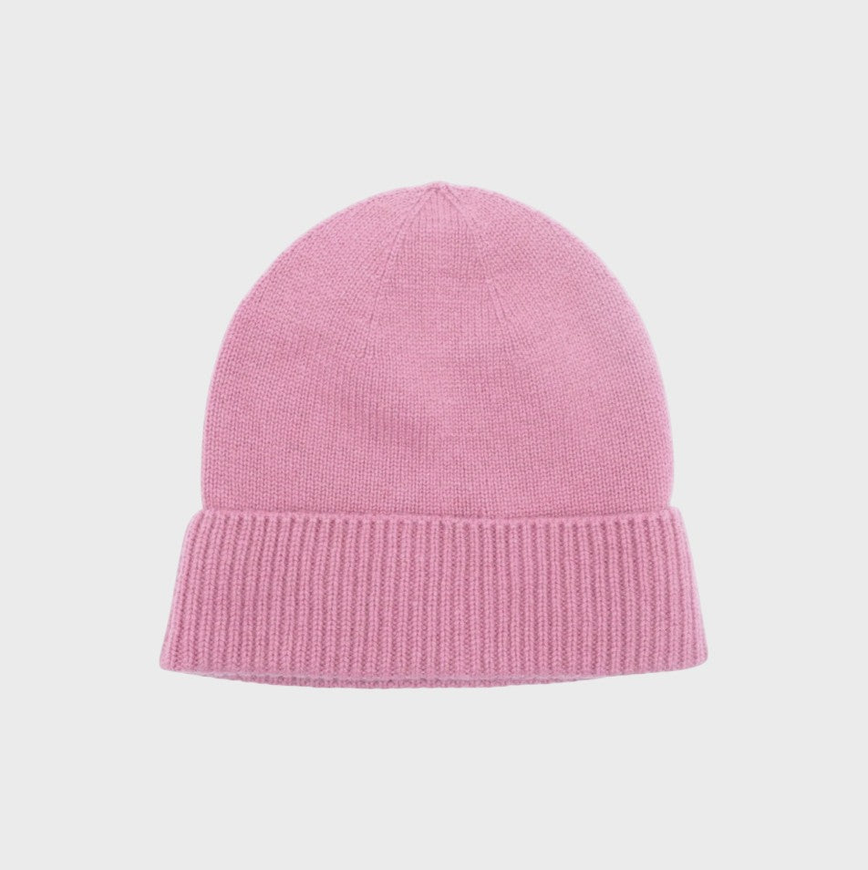 Pink cashmere knit bonnet on a light gray background