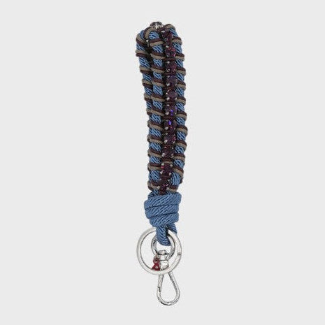 A macramé braided keychain strap featuring a blue and brown pattern, accented with a vertical row of purple rhinestones, and finished with a silver metal lobster clasp on a light gray background.