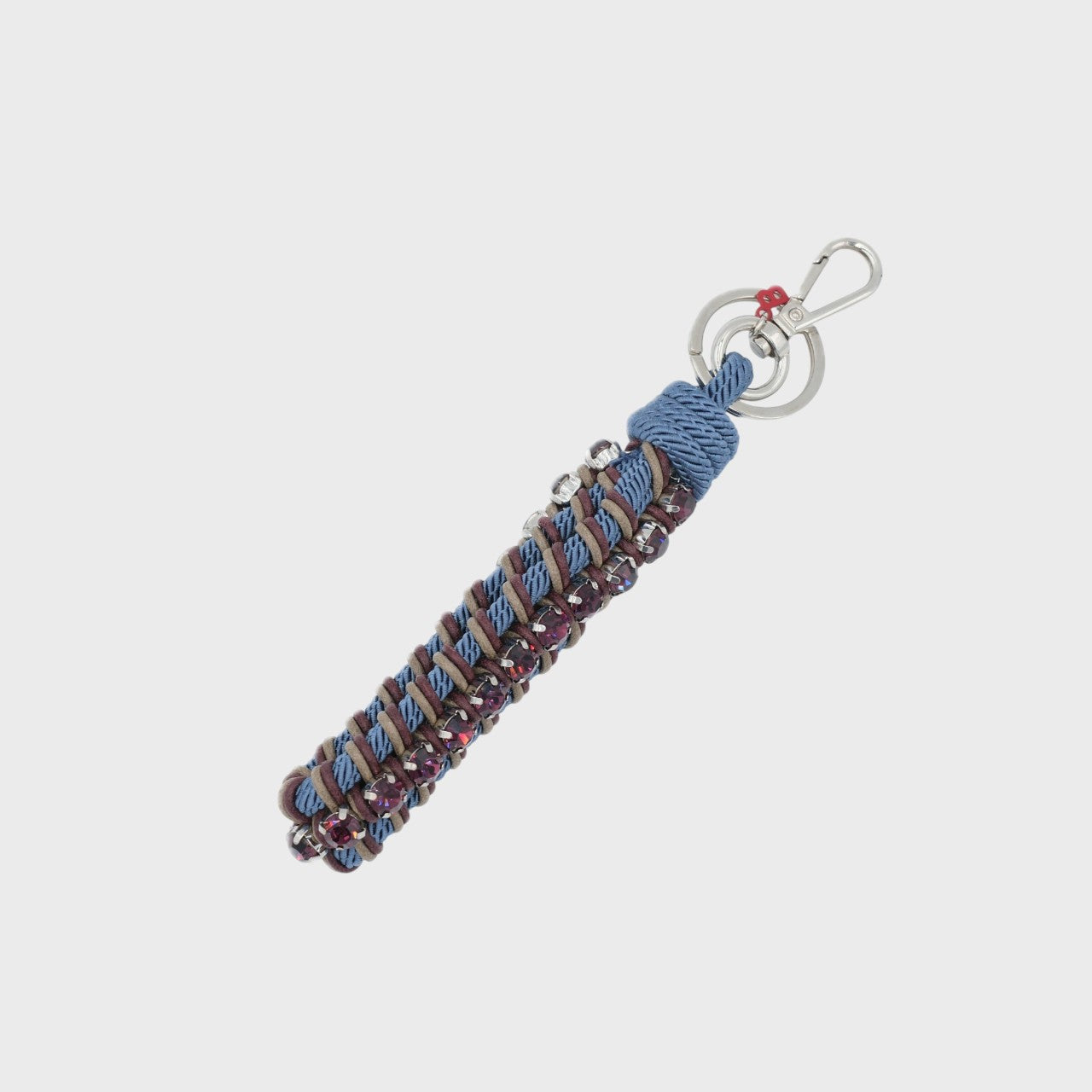 Keychain with blue and brown patterned band and rhinestones on a white background