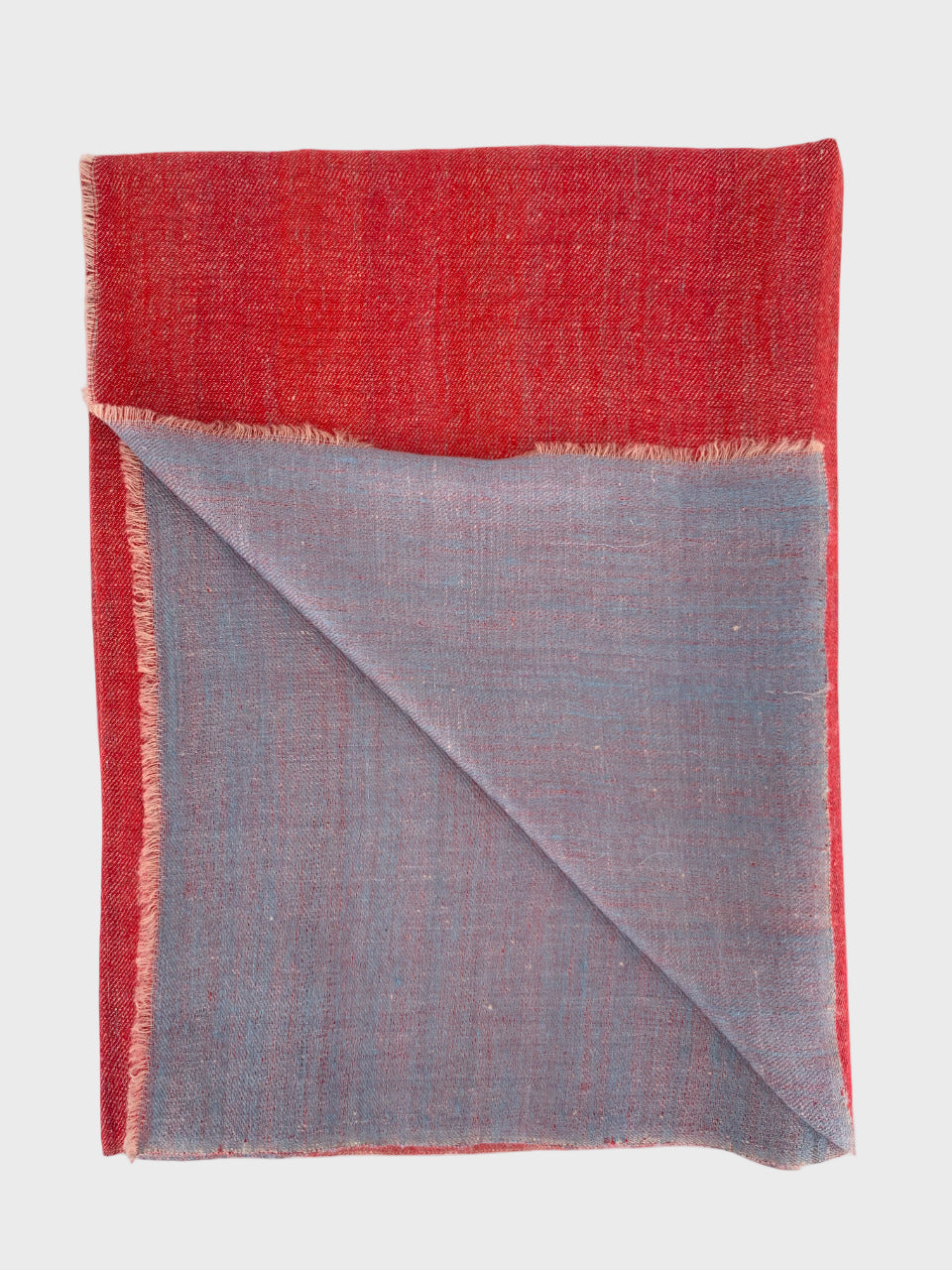 Red and gray cashmere shawl folded on a white background
